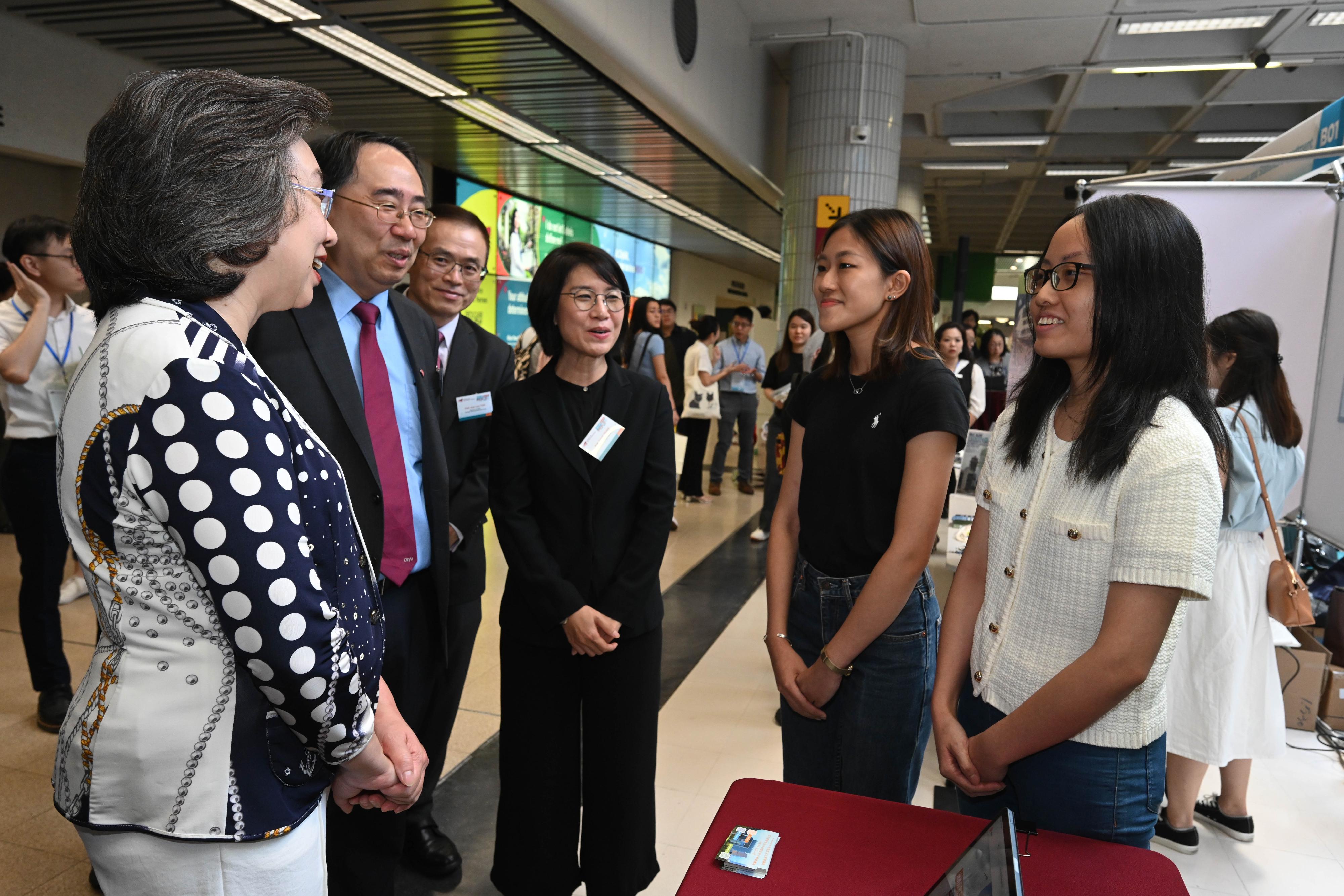 The Secretary for the Civil Service, Mrs Ingrid Yeung, today (September 11) officiated at the opening ceremony of the Government Career Fair at City University of Hong Kong (CityU) to launch a series of Government Career Fairs to be held at local universities and toured the exhibition booths of various government departments. Photo shows Mrs Yeung (first left), and the Provost and Deputy President of CityU, Professor Lee Chun-sing (second left), chatting with students to know their career plans and aspirations.