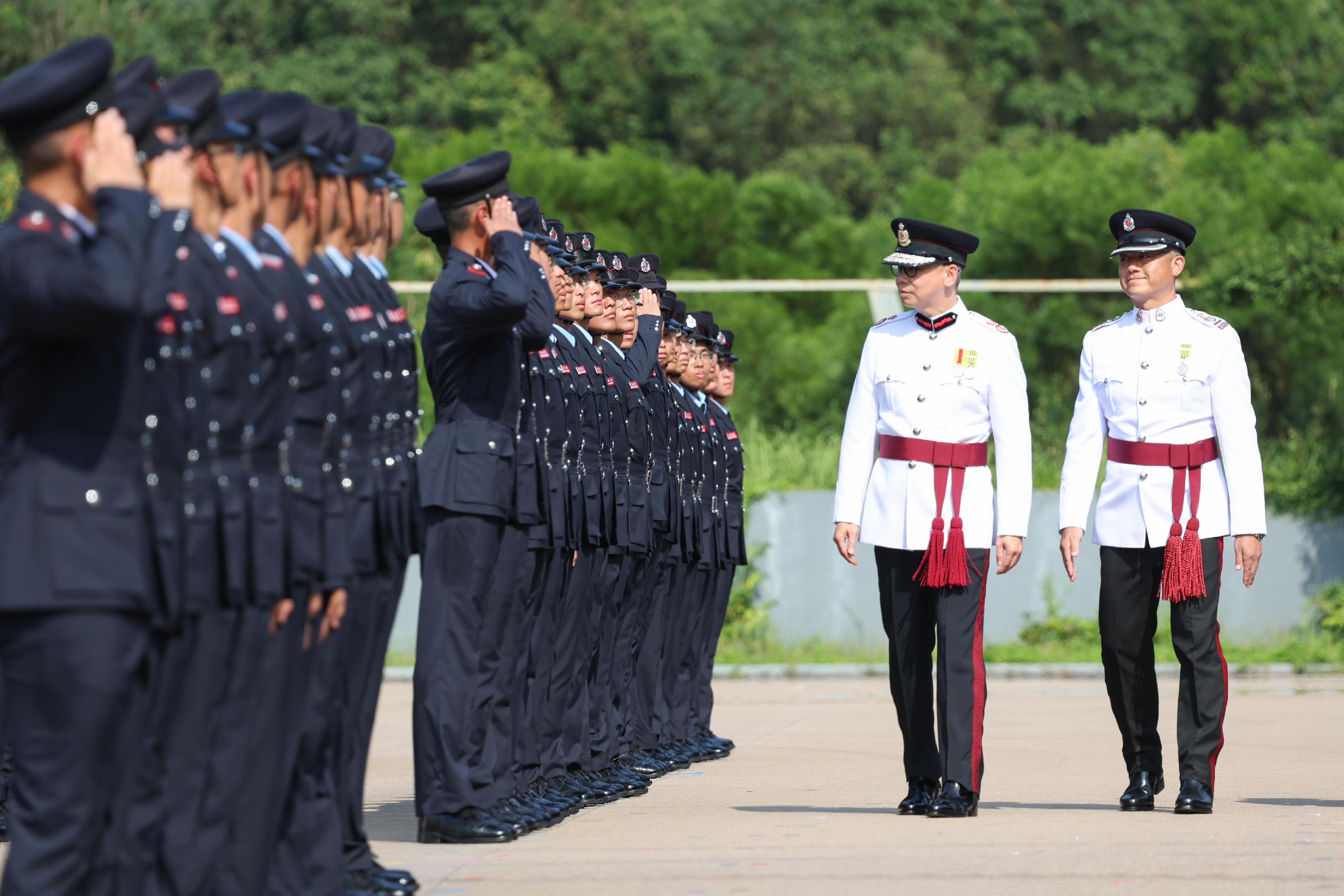 The Deputy Director of Fire Services (Operations), Mr Angus Wong (second right), reviews the Fire Services passing-out parade at the Fire and Ambulance Services Academy today (September 13).