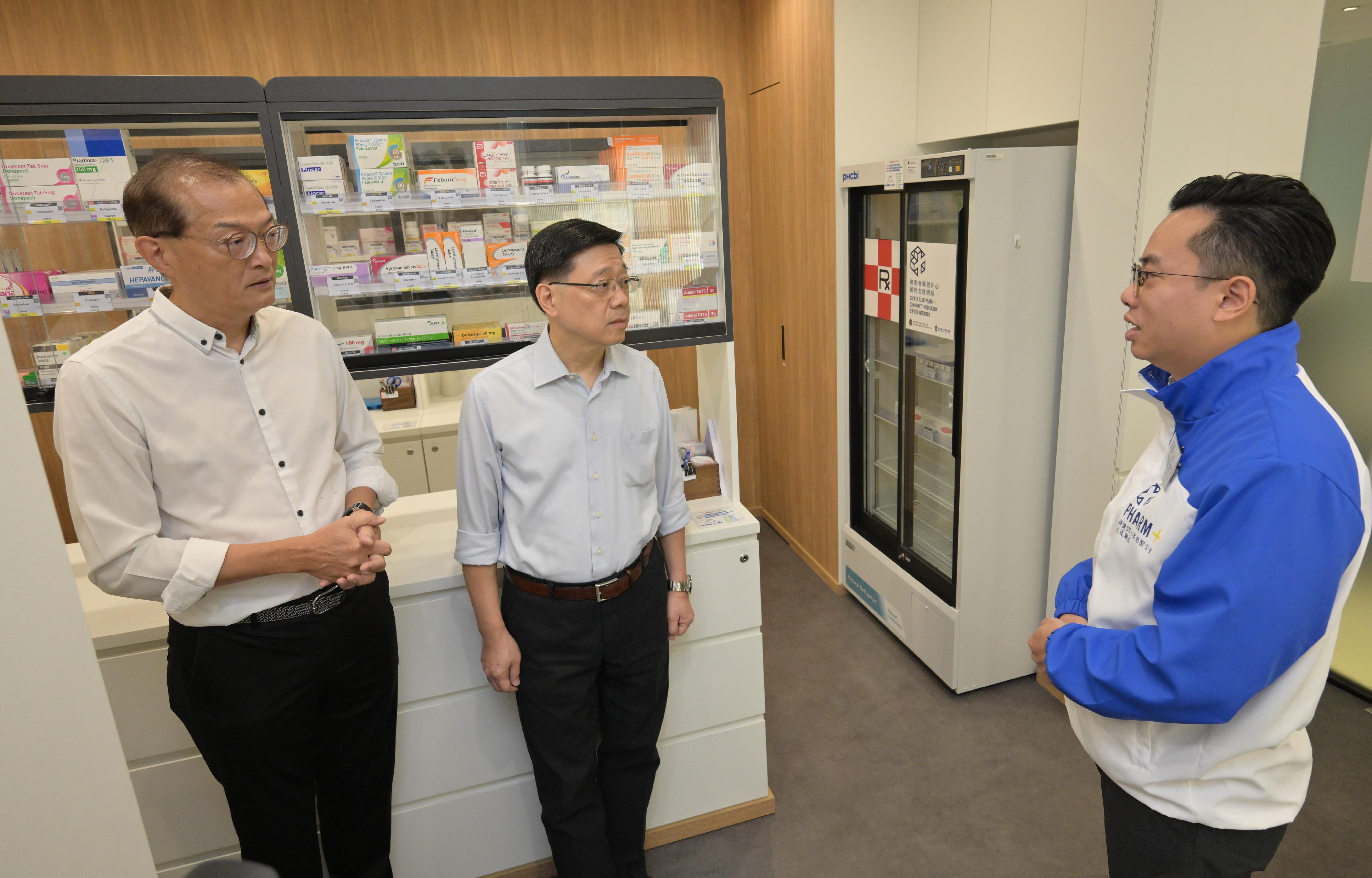 The Chief Executive, Mr John Lee, visited Wong Tai Sin Distrct today (September 14) to gather public views on the upcoming Policy Address. Photo shows Mr Lee (centre) touring a community pharmacy to learn more about its service areas and daily operation.