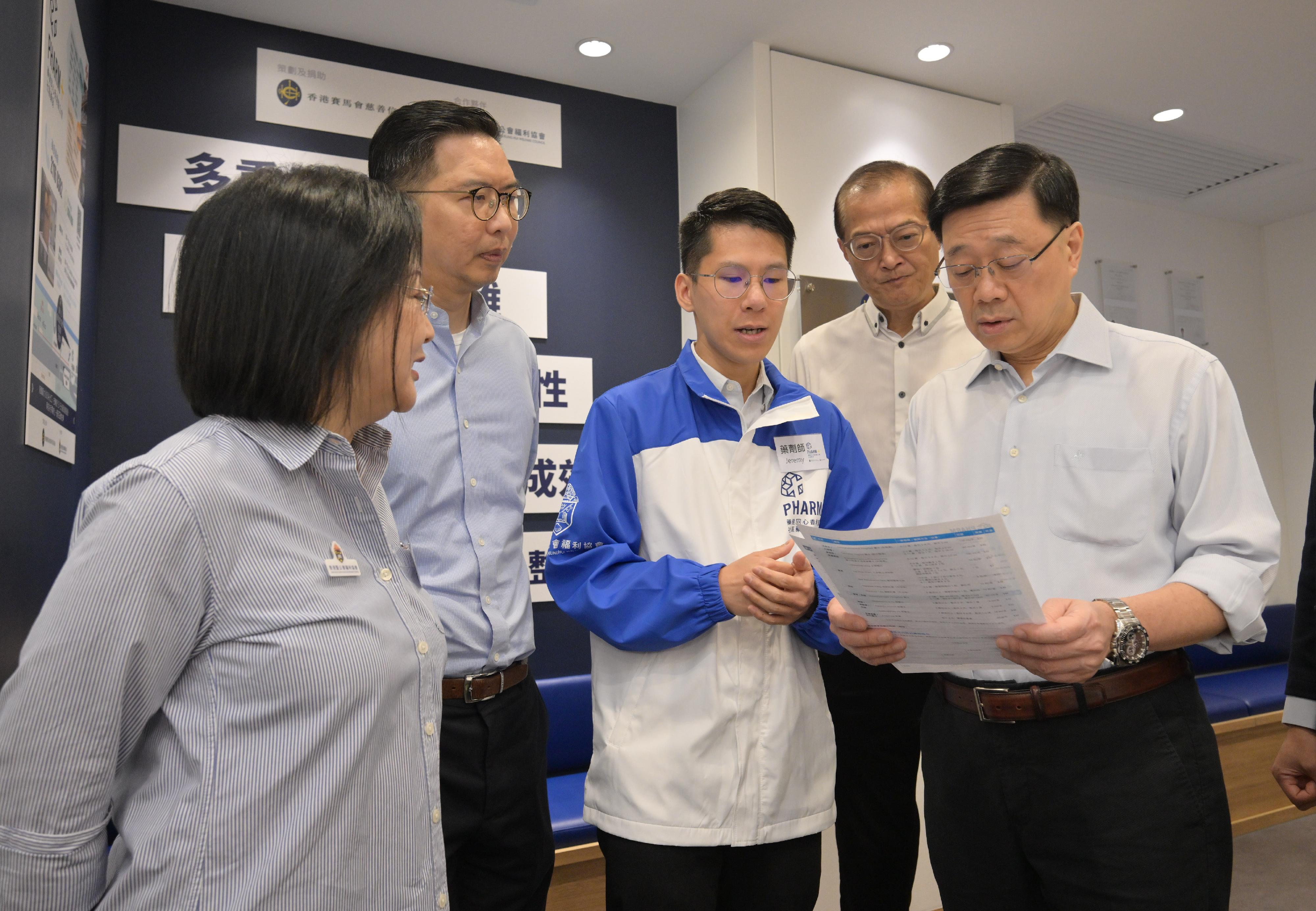 The Chief Executive, Mr John Lee, visited Wong Tai Sin Distrct today (September 14) to gather public views on the upcoming Policy Address. Photo shows Mr Lee (first right) touring a community pharmacy to learn more about its service areas and daily operation. Looking on is the Secretary for Health, Professor Lo Chung-mau (second right).