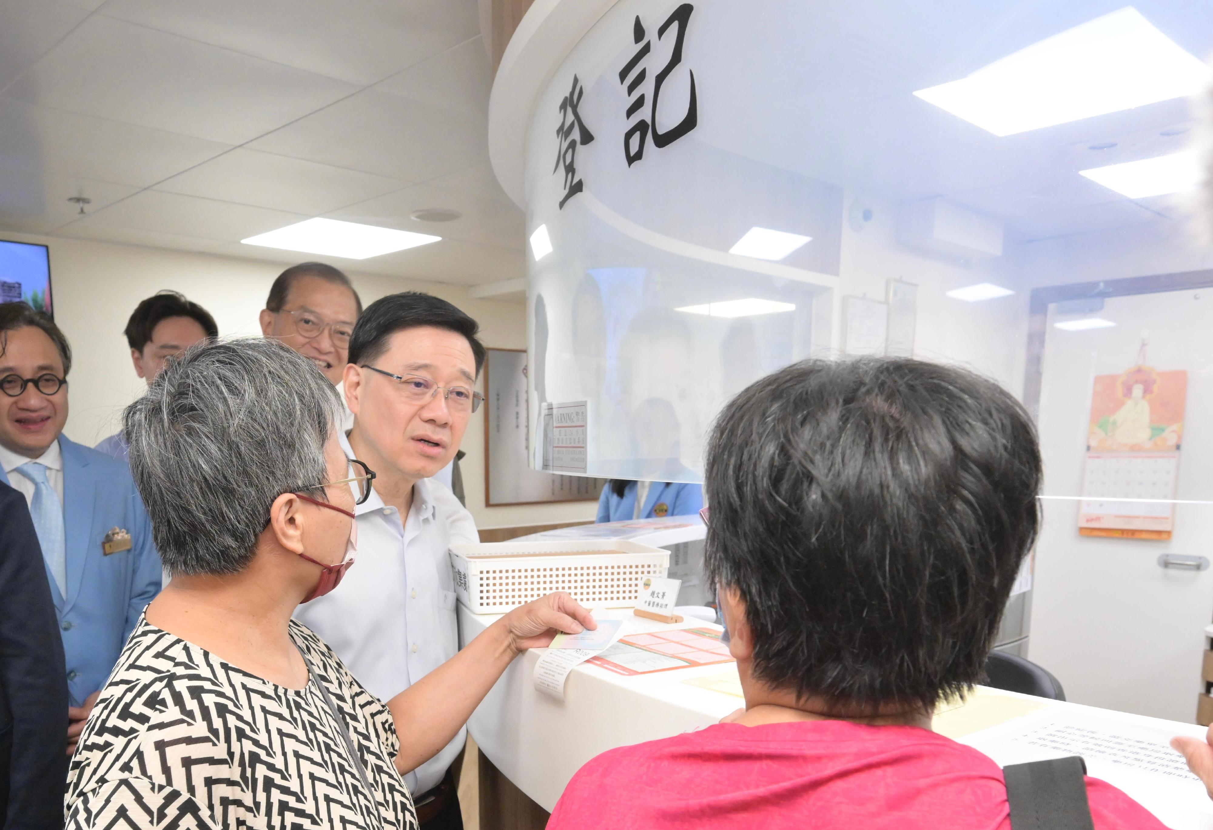 The Chief Executive, Mr John Lee, visited Wong Tai Sin Distrct today (September 14) to gather public views on the upcoming Policy Address. Photo shows Mr Lee touring a Chinese medicine services centre and interacting with members of the public.