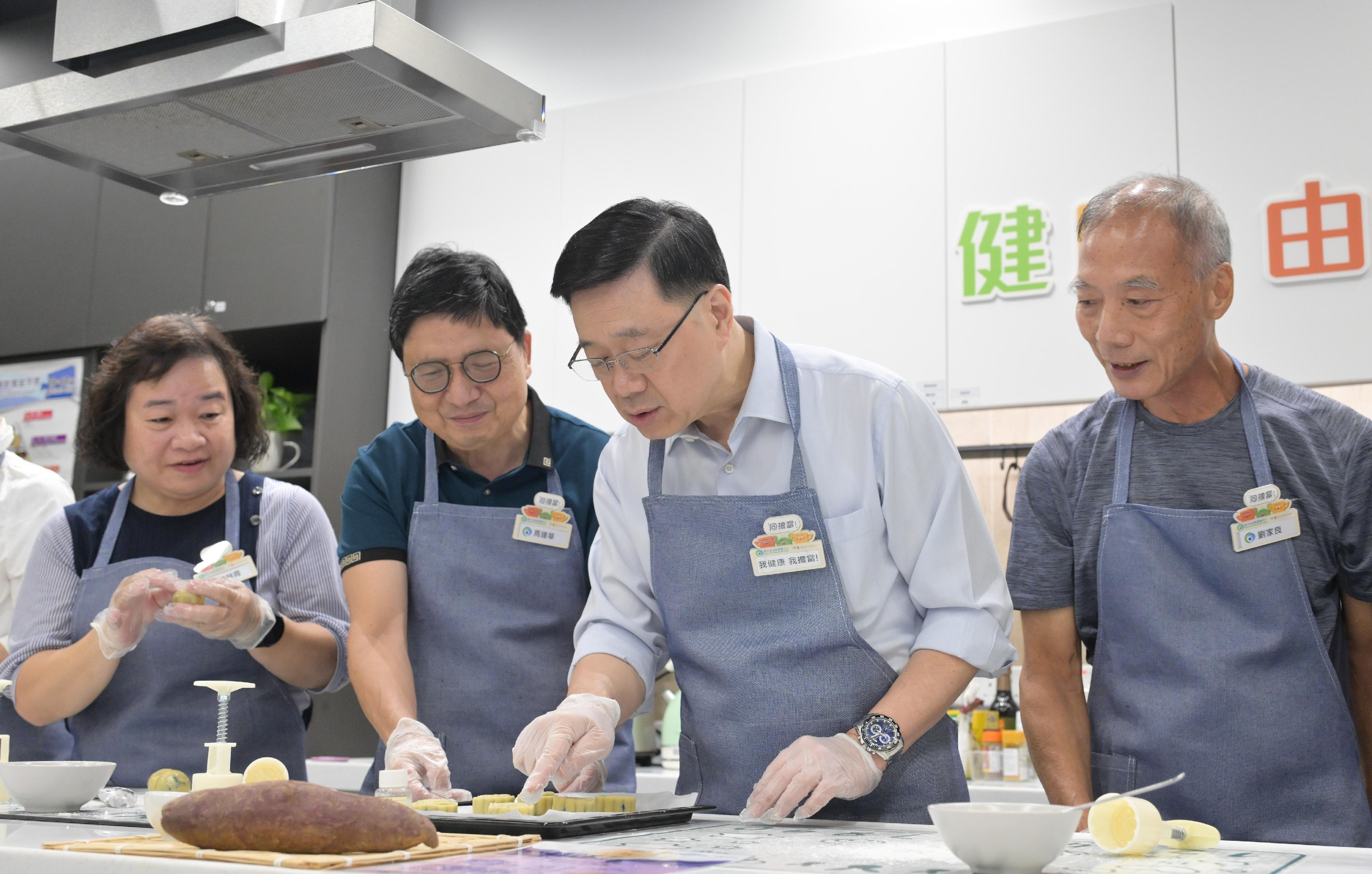 The Chief Executive, Mr John Lee, visited Wong Tai Sin District today (September 14) to gather public views on the upcoming Policy Address. Photo shows Mr Lee (second right) touring a District Health Centre and interacting with members of the public.