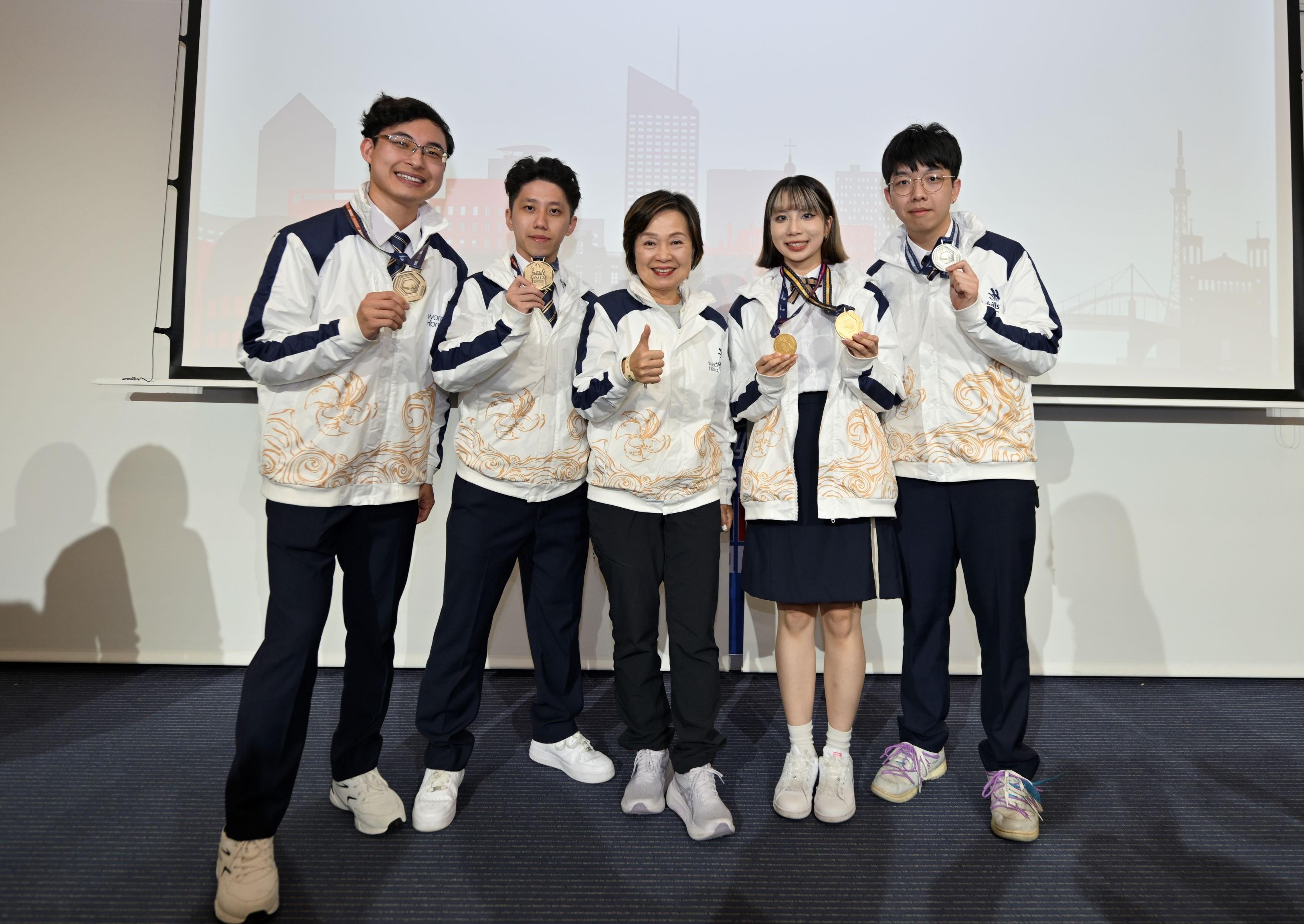 The Secretary for Education, Dr Choi Yuk-lin, witnessed the triumph of the Hong Kong, China delegation, which achieved the best ever results in WorldSkills Lyon 2024 in Lyon, France, on September 15 (France time). Photo shows Dr Choi (centre) with the gold medalist in Visual Merchandising, Chan Wing-ki (second right); the silver medalist in Pâtisserie and Confectionery, Yiu Ho-man (first right); the bronze medalist in Aircraft Maintenance, Wong Fu-tung (first left); and the bronze medalist in Cloud Computing, Wan Ka-chi (second left). 