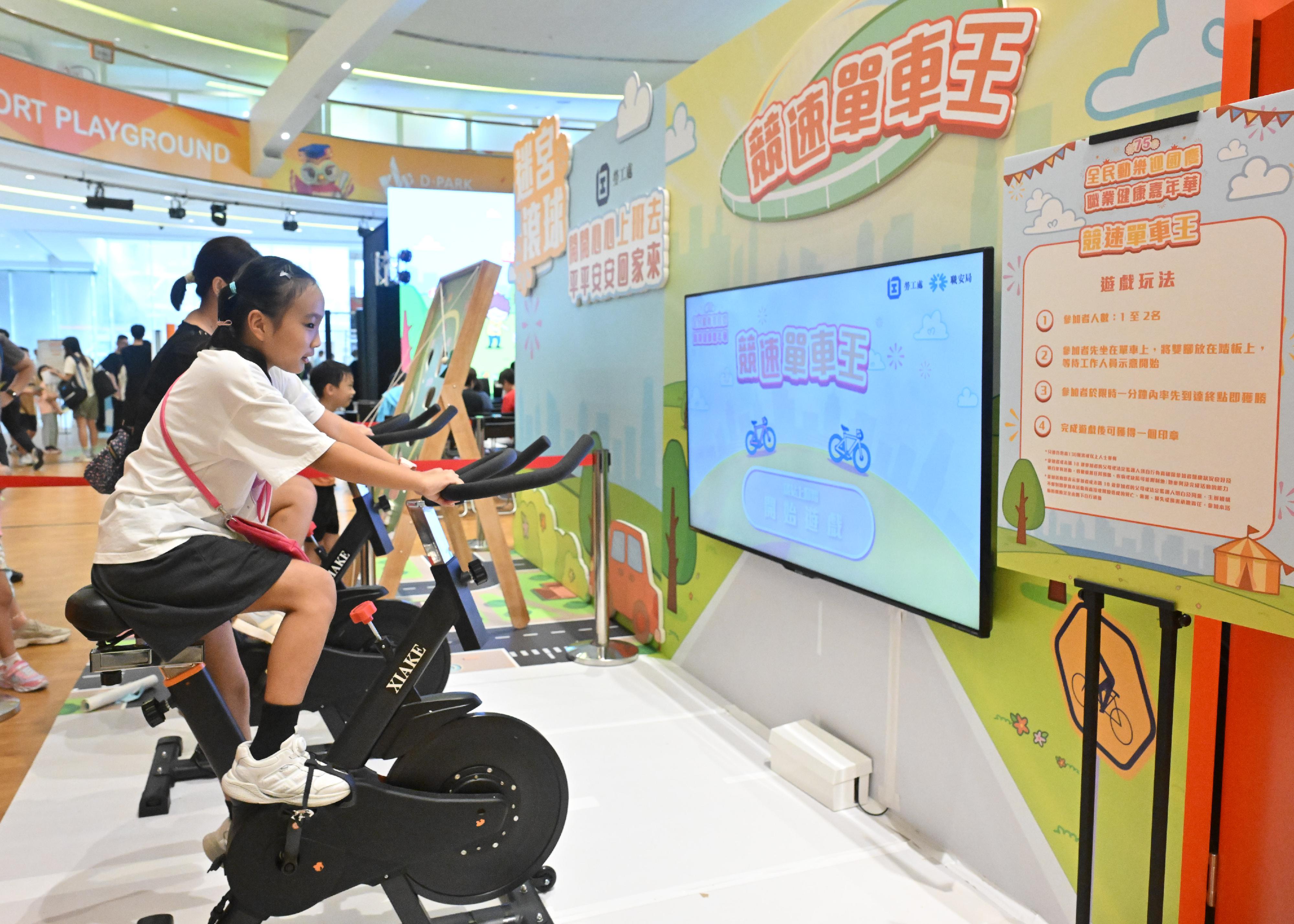 The National Day Celebration and Occupational Health Carnival is being held today and tomorrow (September 21 and 22). Photo shows members of the public participating in the Labour Department’s booth game.
