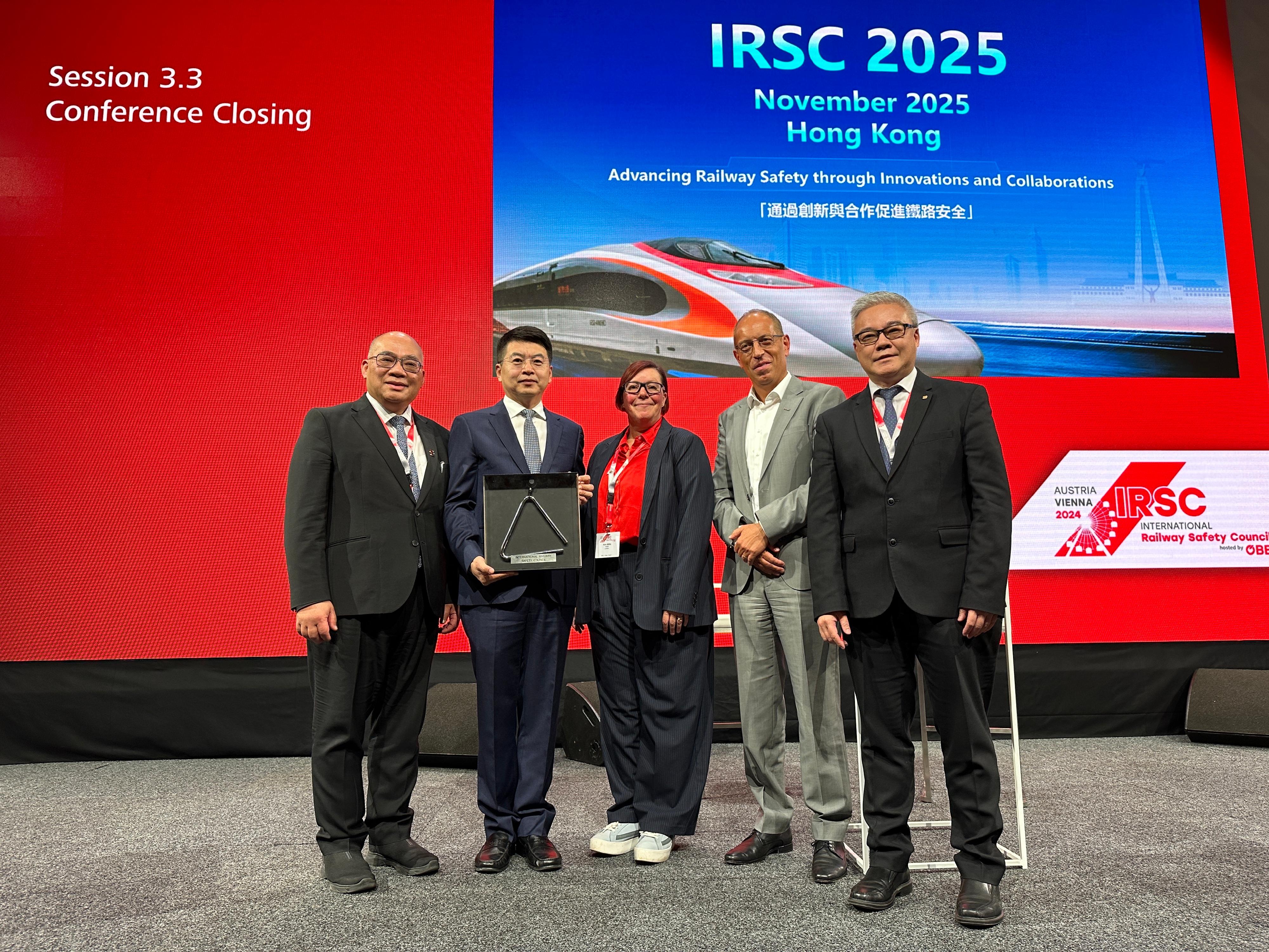 The Director of Electrical and Mechanical Services, Mr Poon Kwok-ying, attended the International Railway Safety Council (IRSC) Conference in Vienna, Austria from September 18 to 20 (Austrian time). Photo shows Mr Poon (first right), together with the Administrator of the National Railway Administration, Mr Fei Dongbin (second left), and the Operations and Innovation Director of the MTR Corporation, Dr Tony Lee (first left), being handed over the “IRSC Triangle” by the Organising Committee Chairman of this year’s Conference (second right) at the closing ceremony, symbolising that Hong Kong, China will be the host city of the next Conference.