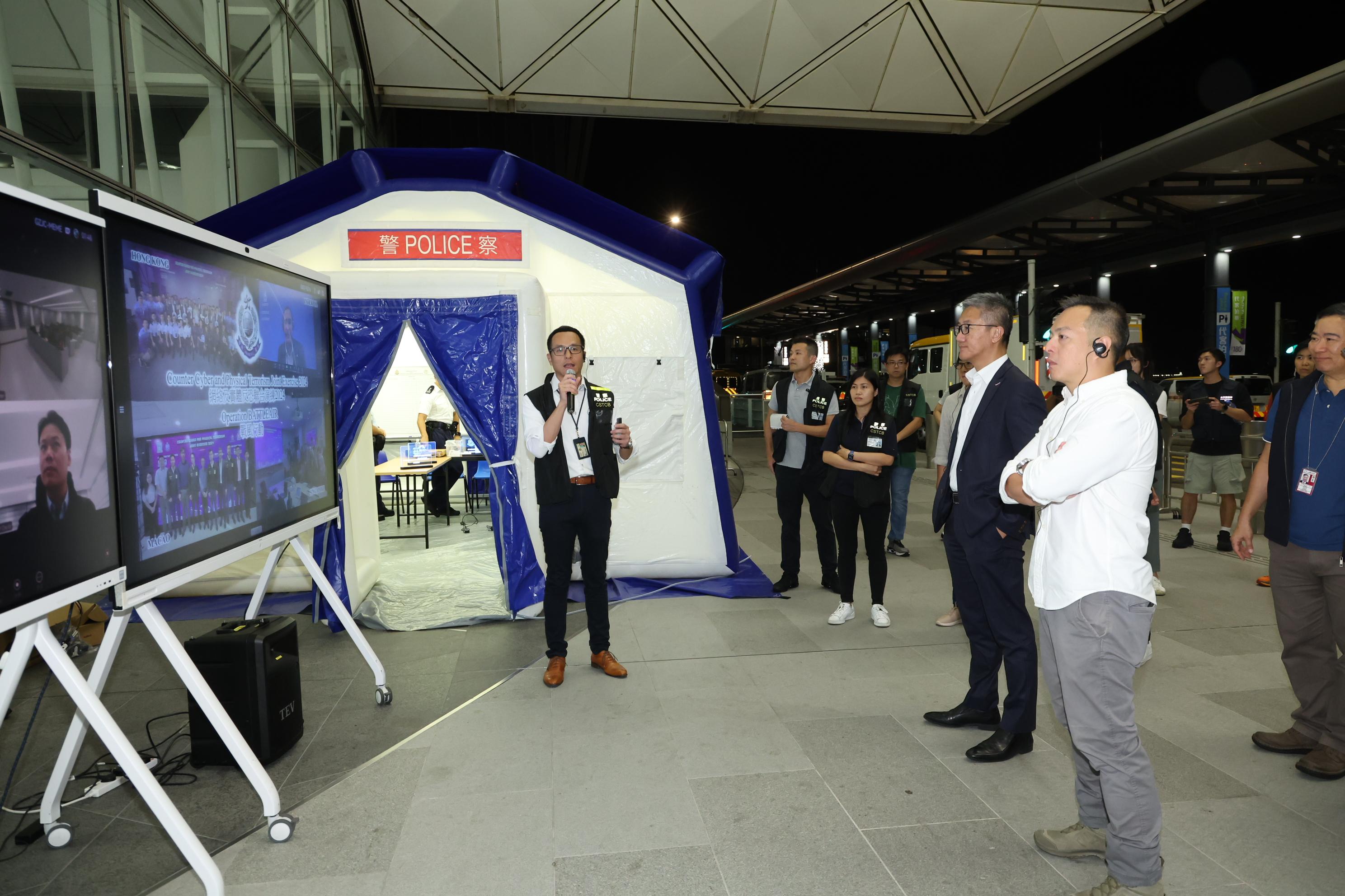 The Cyber Security and Technology Crime Bureau (CSTCB) of the Hong Kong Police Force held the Counter Cyber and Physical Terrorism Joint Exercise 2024 codenamed BATTLEAIR in collaboration with the INTERPOL and the Macao Judiciary Police today (September 21). Photos shows the Commissioner of Police, Mr Siu Chak-yee (third right), and the Deputy Commissioner of Police (Operations), Mr Chow Yat-ming (second right) receiving a briefing on the exercise presented by the Chief Superintendent of the CSTCB, Mr Lam Cheuk-ho (first left).
