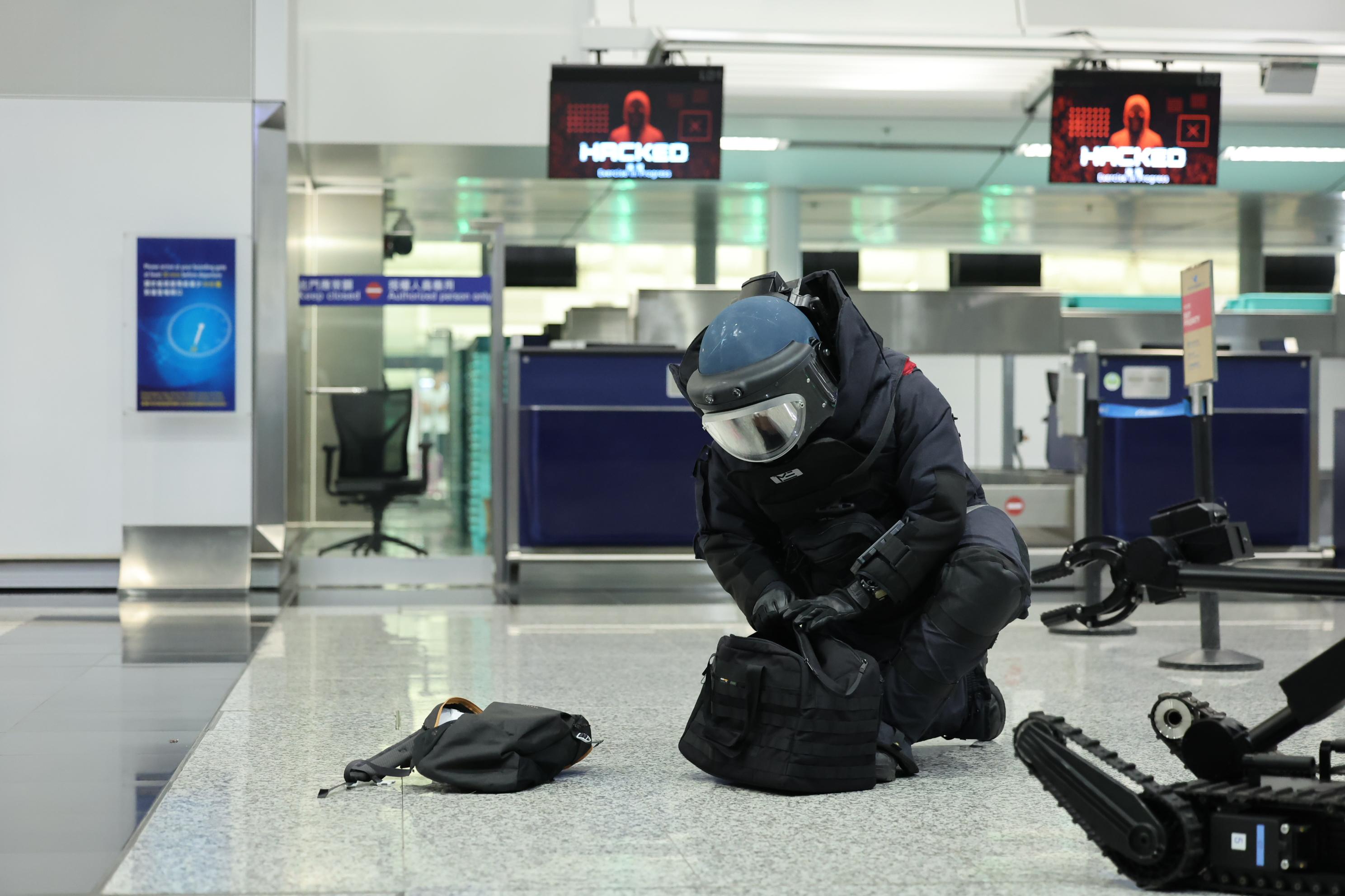 The Cyber Security and Technology Crime Bureau of the Hong Kong Police Force held the Counter Cyber and Physical Terrorism Joint Exercise 2024 codenamed BATTLEAIR in collaboration with the INTERPOL and the Macao Judiciary Police today (September 21). Photo shows officers of the Explosive Ordinance Disposal officers defusing a bomb.
