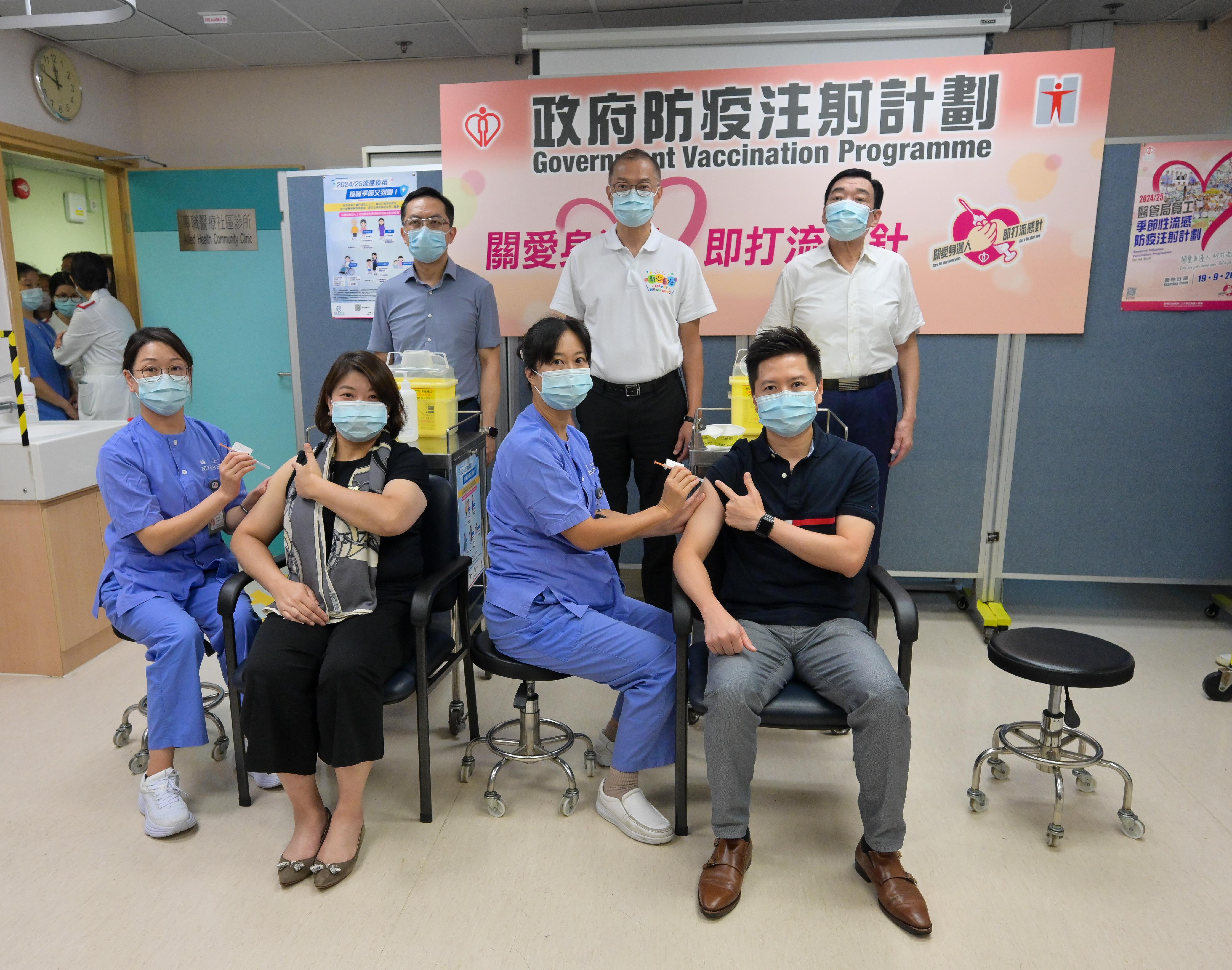 The Under Secretary for Health, Dr Libby Lee (front row, second left), and the Controller of the Centre for Health Protection of the Department of Health, Dr Edwin Tsui (front row, first right), receive vaccinations against seasonal influenza and COVID-19 at Sai Wan Ho General Out-patient Clinic today (September 24). Looking on are the Secretary for Health, Professor Lo Chung-mau (back row, centre); the Director of Health, Dr Ronald Lam (back row, first left); and the Chairman of the Hospital Authority, Mr Henry Fan (back row, first right).