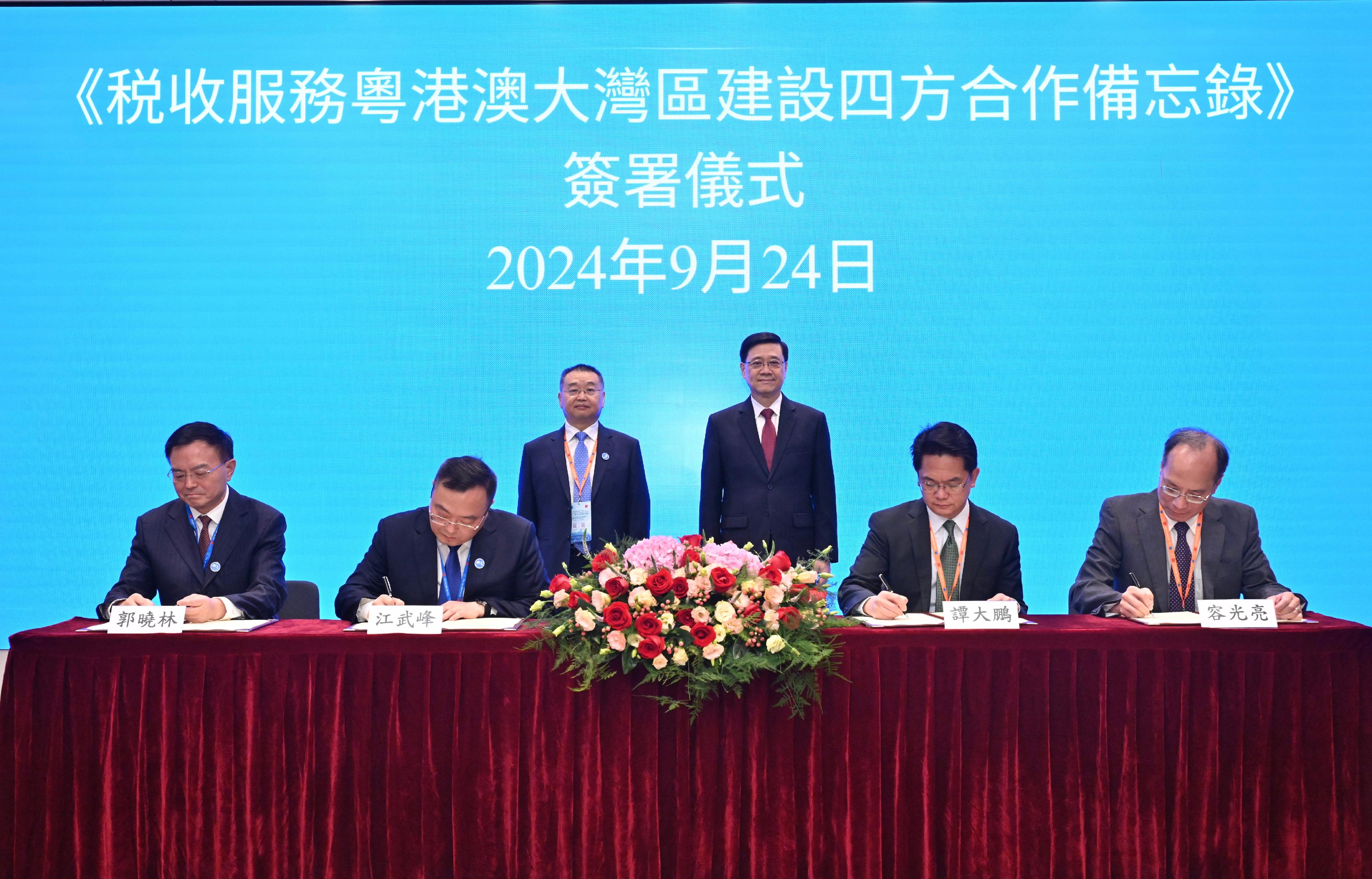 The Chief Executive, Mr John Lee (back row, right), and the Commissioner of the State Taxation Administration, Mr Hu Jinglin (back row, left), today (September 24) witnessed the signing of a memorandum of understanding on tax co-operation within the Guangdong-Hong Kong-Macao Greater Bay Area among the finance and taxation departments of Guangdong Province, Shenzhen, the Hong Kong Special Administrative Region and the Macao Special Administrative Region (SAR) on the margins of the 5th Belt and Road Initiative Tax Administration Cooperation Forum. Photo also shows representatives from the finance and taxation departments of the four places: (front row, from left) the Director General of Shenzhen Tax Service of the State Taxation Administration, Mr Guo Xiaolin; the Director General of Guangdong Provincial Tax Service of the State Taxation Administration, Mr Jiang Wufeng; the Commissioner of Inland Revenue, Mr Tam Tai-pang; and the Director of Financial Services Bureau of the Macao SAR, Mr Iong Kong-leong.