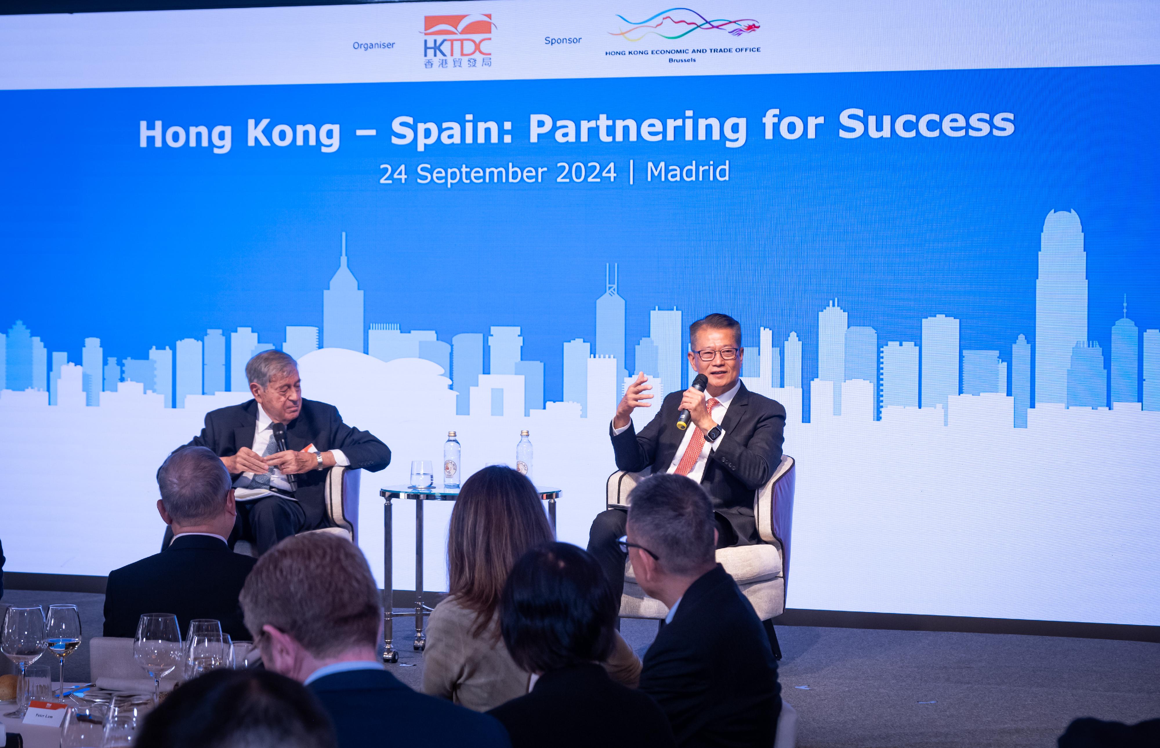 The Financial Secretary, Mr Paul Chan, attended the business luncheon Hong Kong-Spain: Partnering for Success in Madrid, Spain, today (September 24, Madrid time) to promote business opportunities in Hong Kong to Spanish business sector.  Photo shows Mr Chan (right) in a dialogue session with Professor Pedro Nueno of the Business School of IE University of Spain.