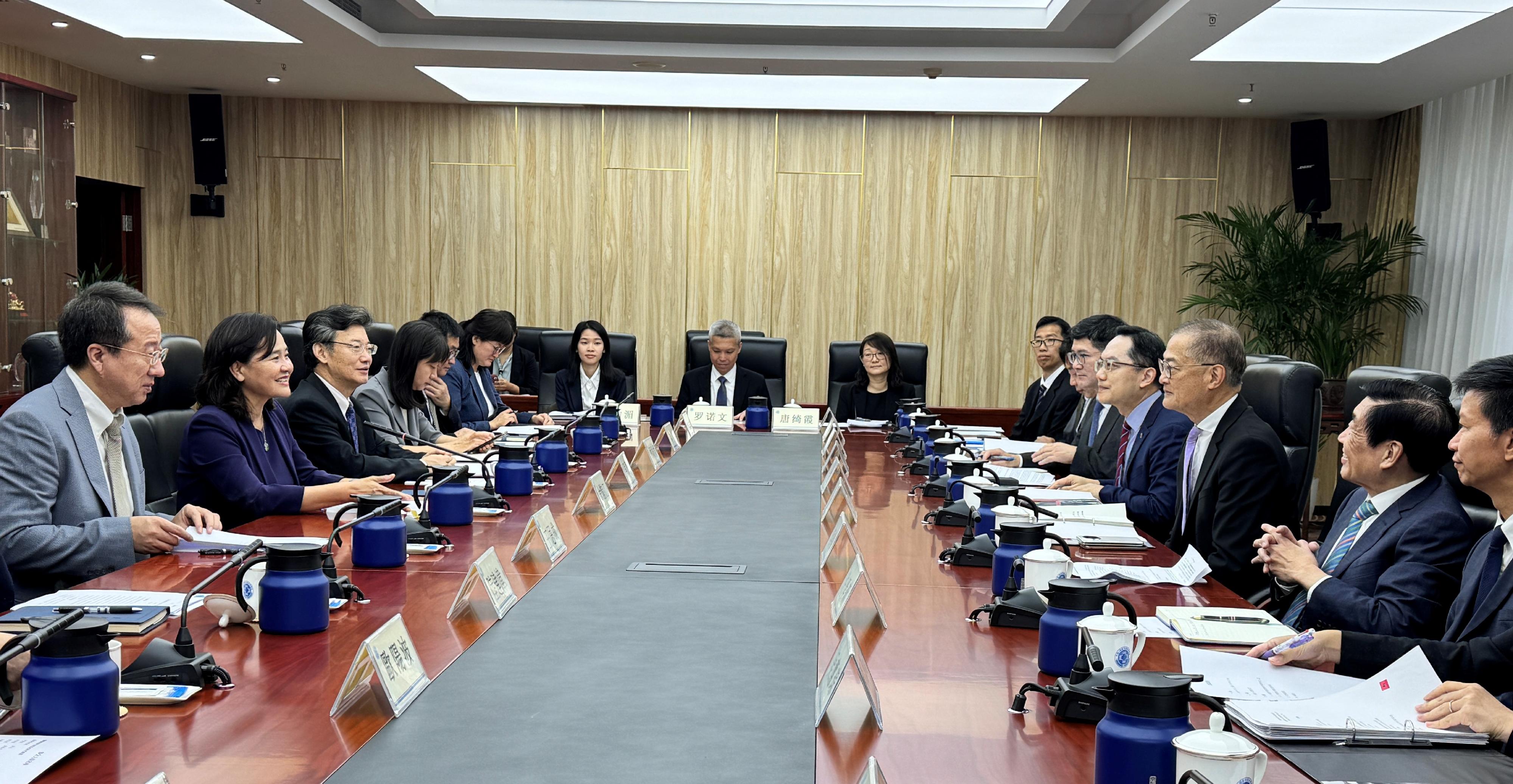 The Secretary for Health, Professor Lo Chung-mau (third right), and his delegation meet with the Commissioner of the National Administration of Traditional Chinese Medicine, Professor Yu Yanhong (second left), in Beijing today (September 26) to discuss issues related to the promotion of the development of Chinese medicine. The Director of Health, Dr Ronald Lam (fourth right); Deputy Secretary for Health Mr Sam Hui (first right); the Chairman of the Hospital Authority (HA), Mr Henry Fan (second right); and the Chief Executive of the HA, Dr Tony Ko (fifth right), also attend the meeting.