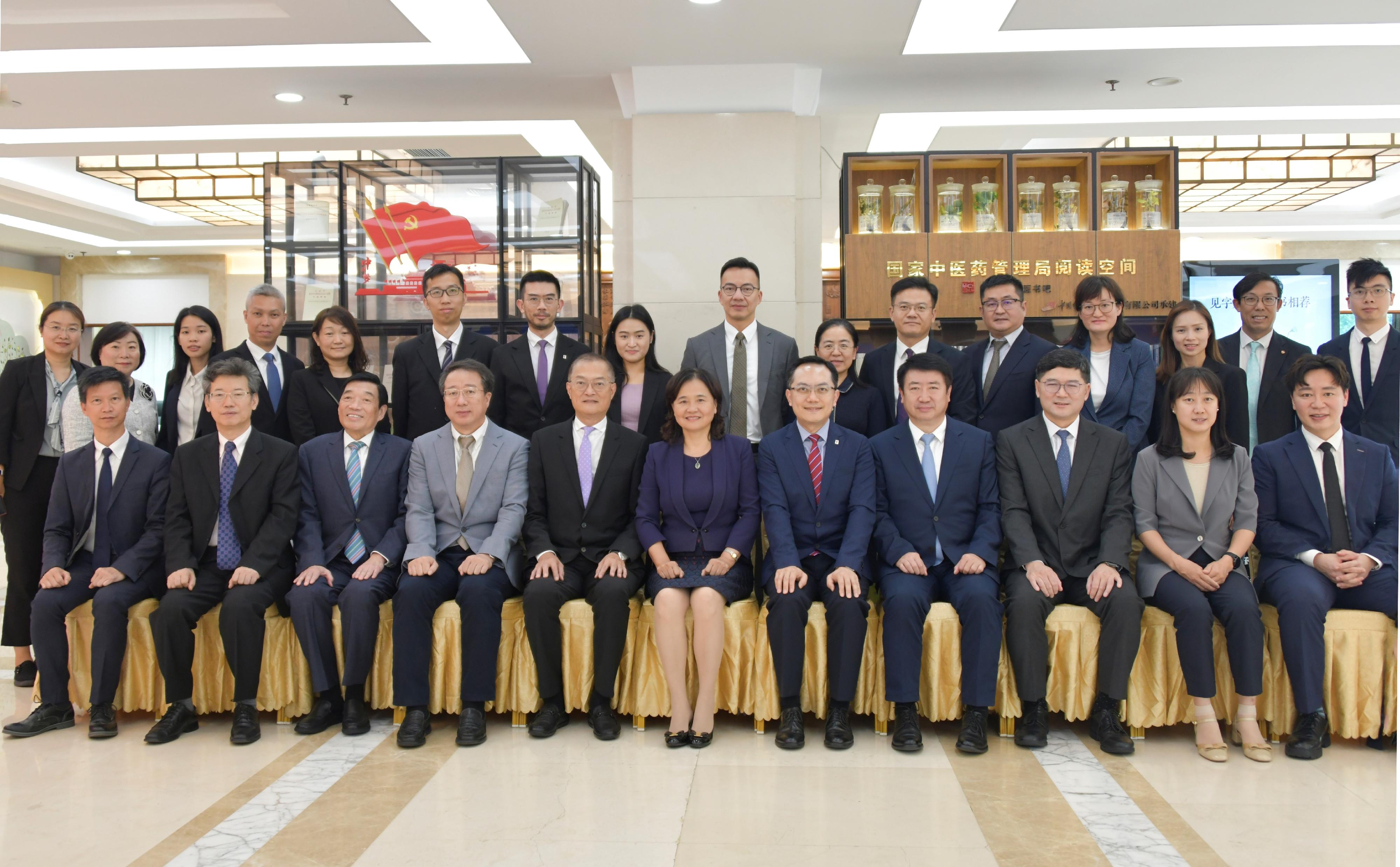 The Secretary for Health, Professor Lo Chung-mau, and his delegation met with the Commissioner of the National Administration of Traditional Chinese Medicine, Professor Yu Yanhong, in Beijing today (September 26) to discuss issues related to the promotion of the development of Chinese medicine. Photo shows Professor Lo (front row, fifth left); Professor Yu (front row, centre); the Director of Health, Dr Ronald Lam (front row, fifth right); Deputy Secretary for Health Mr Sam Hui (front row, first left); the Chairman of the Hospital Authority (HA), Mr Henry Fan (front row, third left); the Chief Executive of the HA, Dr Tony Ko (front row, third right), and other attendees after the meeting.