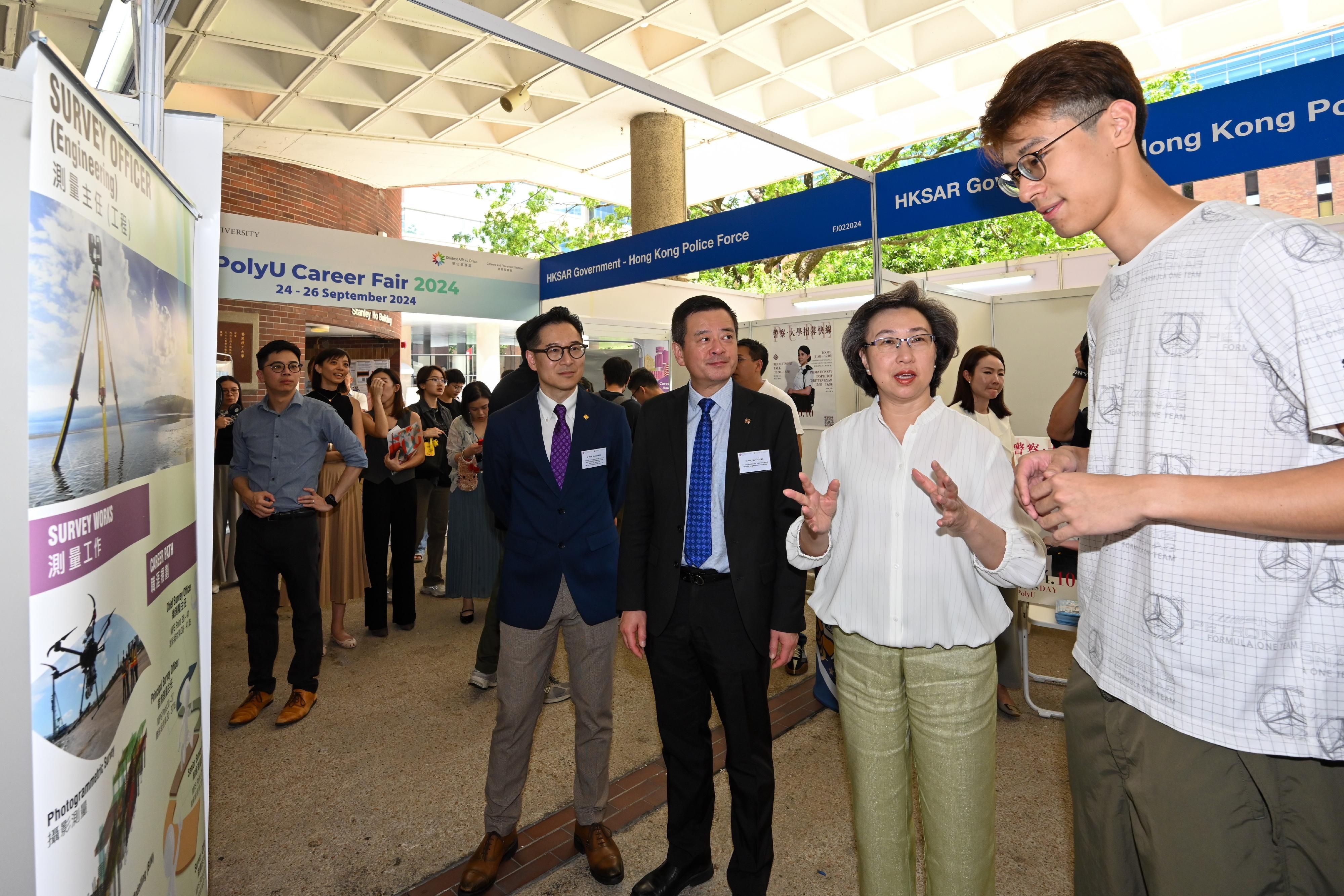 The Secretary for the Civil Service, Mrs Ingrid Yeung, attended the Government Career Fair at the Hong Kong Polytechnic University (PolyU) today (September 26). Photo shows Mrs Yeung (second right) chatting with a student studying surveying. Looking on is the Vice President (Student and Global Affairs) of PolyU, Professor Ben Young (third right).