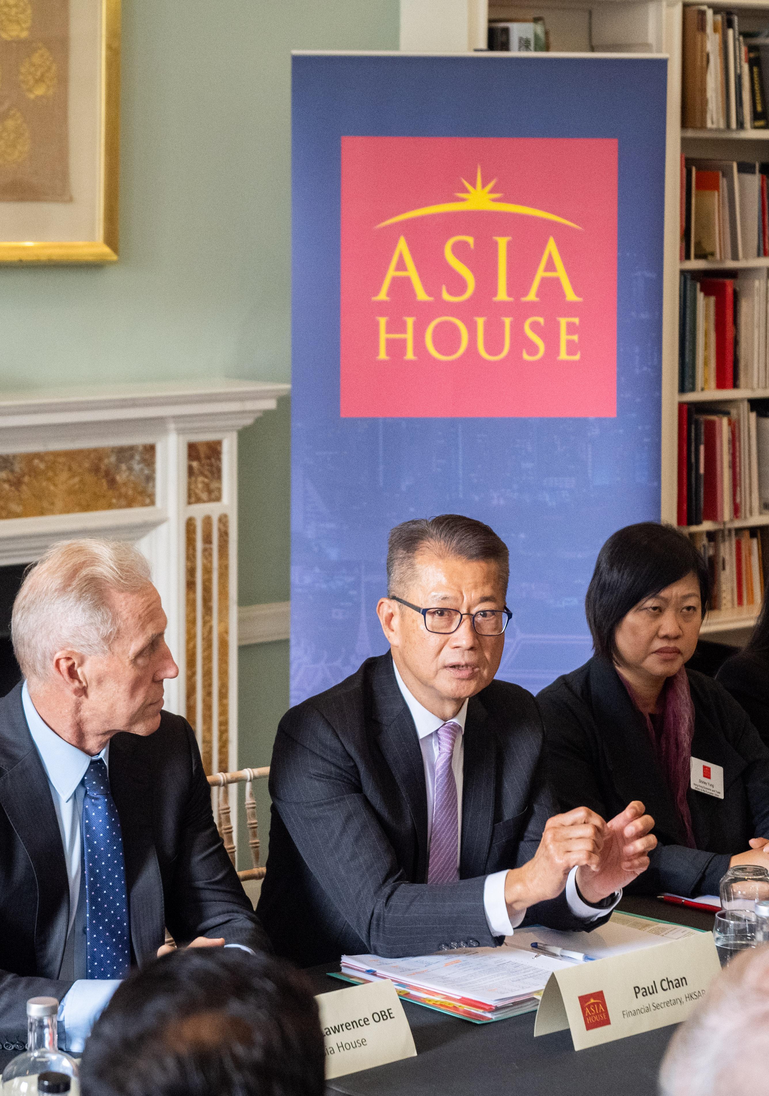 The Financial Secretary, Mr Paul Chan (centre), speaks at a roundtable meeting hosted by Asia House, a think tank based in the United Kingdom, held in London yesterday (September 26, London time).