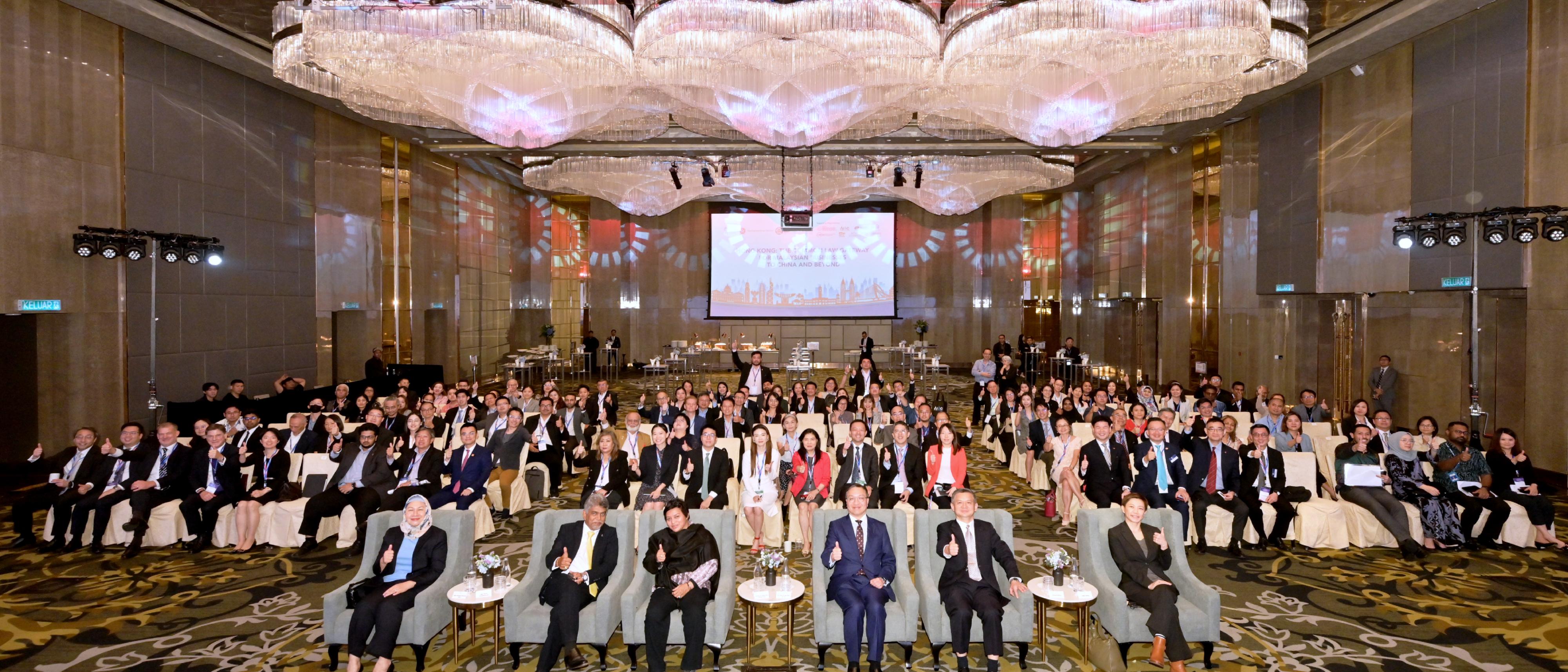 The Secretary for Justice, Mr Paul Lam, SC, leading a delegation comprising representatives from the Law Society of Hong Kong, the Hong Kong Bar Association and alternative dispute resolution organisations, attended a seminar titled "Hong Kong: The Common Law Gateway for Malaysian Businesses to China and Beyond", followed by an evening networking reception co-organised by the Department of Justice, the Hong Kong Economic and Trade Office in Jakarta and the National Chamber of Commerce and Industry of Malaysia in Kuala Lumpur, Malaysia today (September 26). Photo shows Mr Lam (first row, third right); the Malaysia's Minister in the Prime Minister's Department (Law and Institutional Reform), Dato' Sri Azalina Othman Said (first row, third left); and the Chargé d'Affaires of the Chinese Embassy in Malaysia, Mr Zheng Xuefang (first row, second right) with other guests at the seminar.