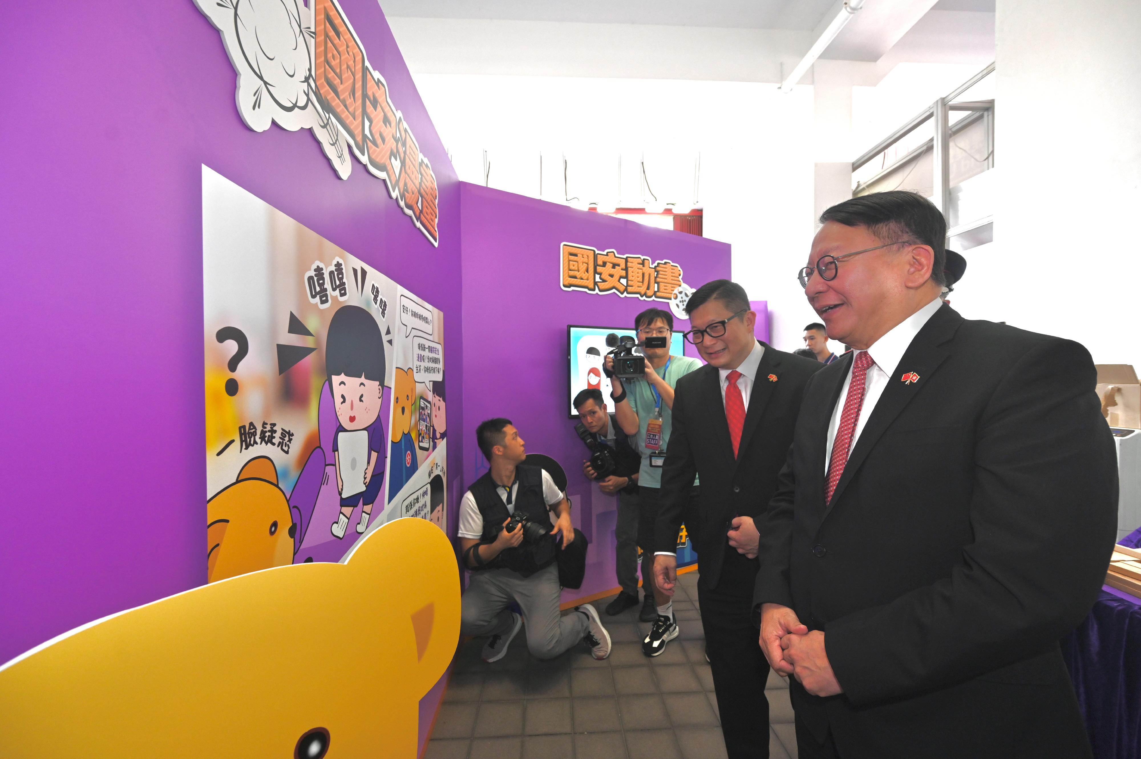 The Chief Secretary for Administration, Mr Chan Kwok-ki, attended the Grand Parade by Disciplined Services and Youth Groups cum Fun Day for Celebrating the 75th Anniversary of the Founding of the People's Republic of China today (October 1). Photo shows Mr Chan (first right) touring the exhibition and game booths. Looking on is the Secretary for Security, Mr Tang Ping-keung (second right).