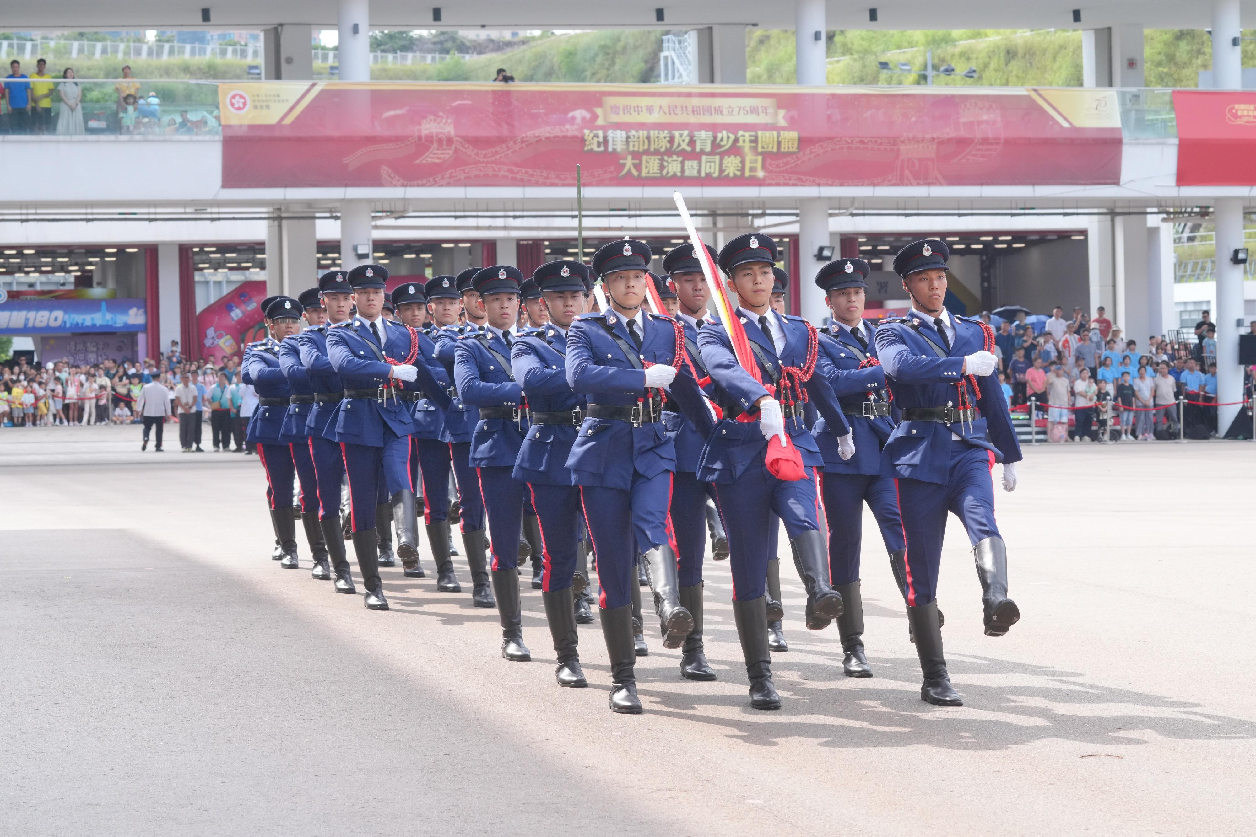 The Security Bureau led its disciplined services and auxiliary services, together with youth uniformed groups, to hold the Grand Parade by Disciplined Services and Youth Groups cum Fun Day for Celebrating the 75th Anniversary of the Founding of the People's Republic of China at the Fire and Ambulance Services Academy in Tseung Kwan O today (October 1). Photo shows the disciplined services ceremonial guard and the youth uniformed groups marching onto the venue with the Chinese-style foot drill.
