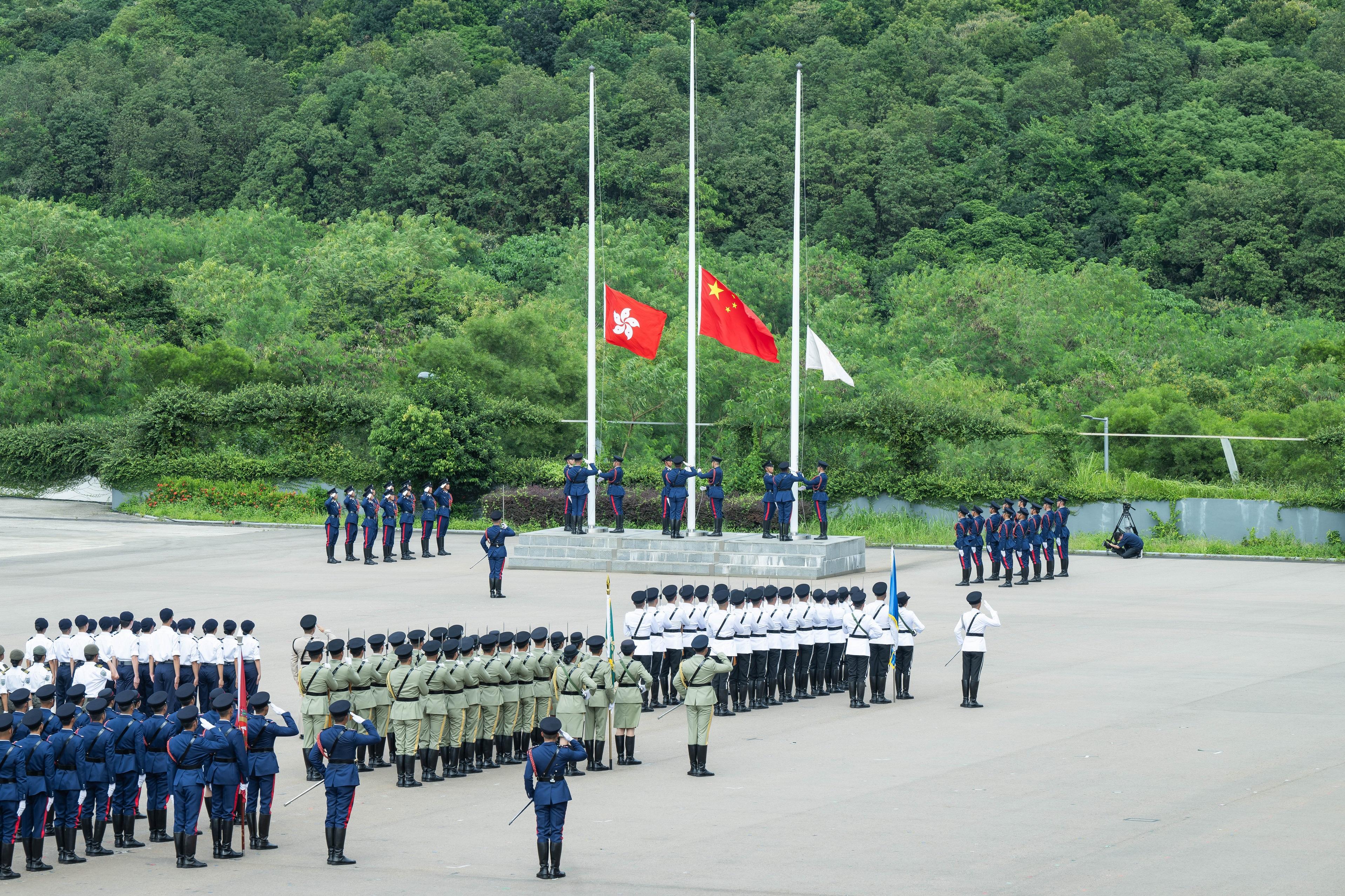 The Security Bureau led its disciplined services and auxiliary services, together with youth uniformed groups, to hold the Grand Parade by Disciplined Services and Youth Groups cum Fun Day for Celebrating the 75th Anniversary of the Founding of the People's Republic of China at the Fire and Ambulance Services Academy in Tseung Kwan O today (October 1). Photo shows the Fire Services Department flag party conducting a flag-raising ceremony.