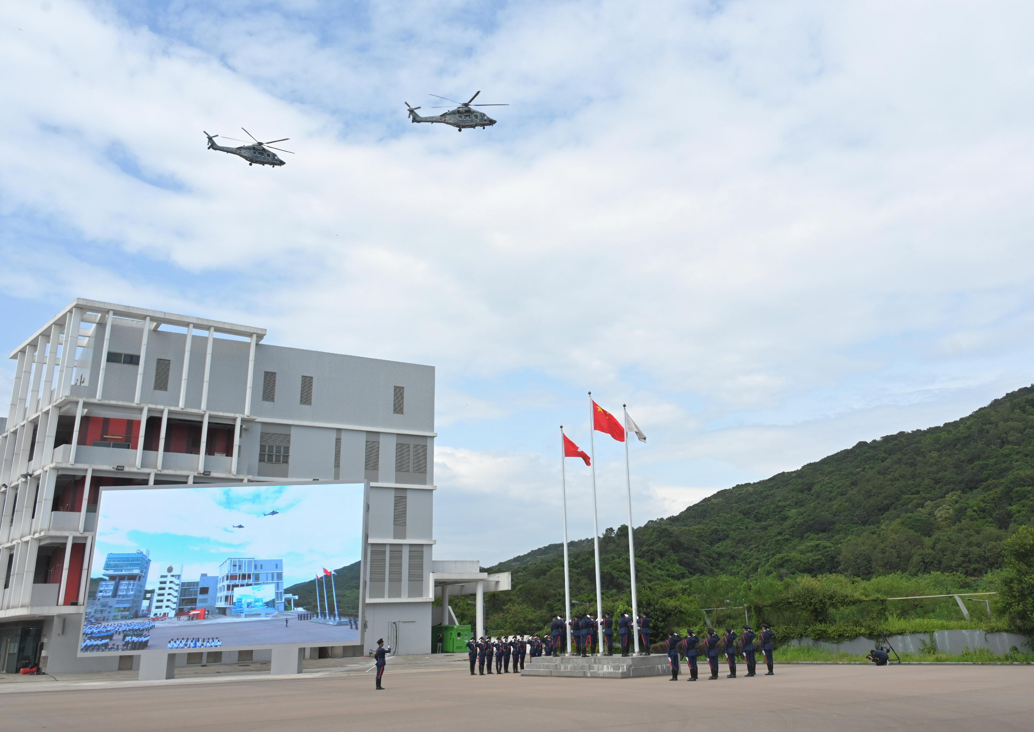 The Security Bureau led its disciplined services and auxiliary services, together with youth uniformed groups, to hold the Grand Parade by Disciplined Services and Youth Groups cum Fun Day for Celebrating the 75th Anniversary of the Founding of the People's Republic of China at the Fire and Ambulance Services Academy in Tseung Kwan O today (October 1). Photo shows the disciplined services ceremonial guard and youth uniformed groups lining up at the flag-raising ceremony.
