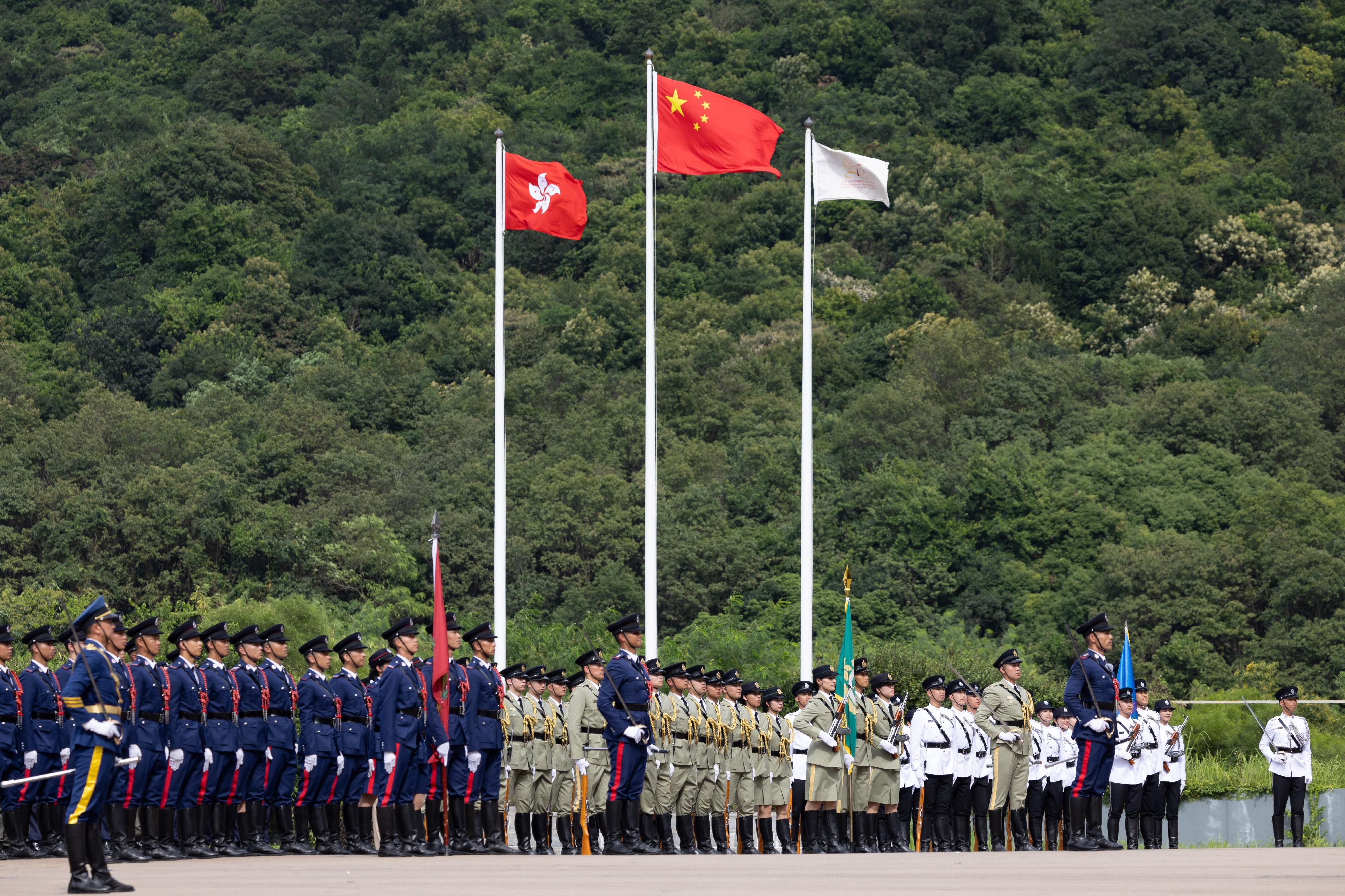 The Security Bureau led its disciplined services and auxiliary services, together with youth uniformed groups, to hold the Grand Parade by Disciplined Services and Youth Groups cum Fun Day for Celebrating the 75th Anniversary of the Founding of the People's Republic of China at the Fire and Ambulance Services Academy in Tseung Kwan O today (October 1). Photo shows the disciplined services ceremonial guard and youth uniformed groups lining up at the flag-raising ceremony.