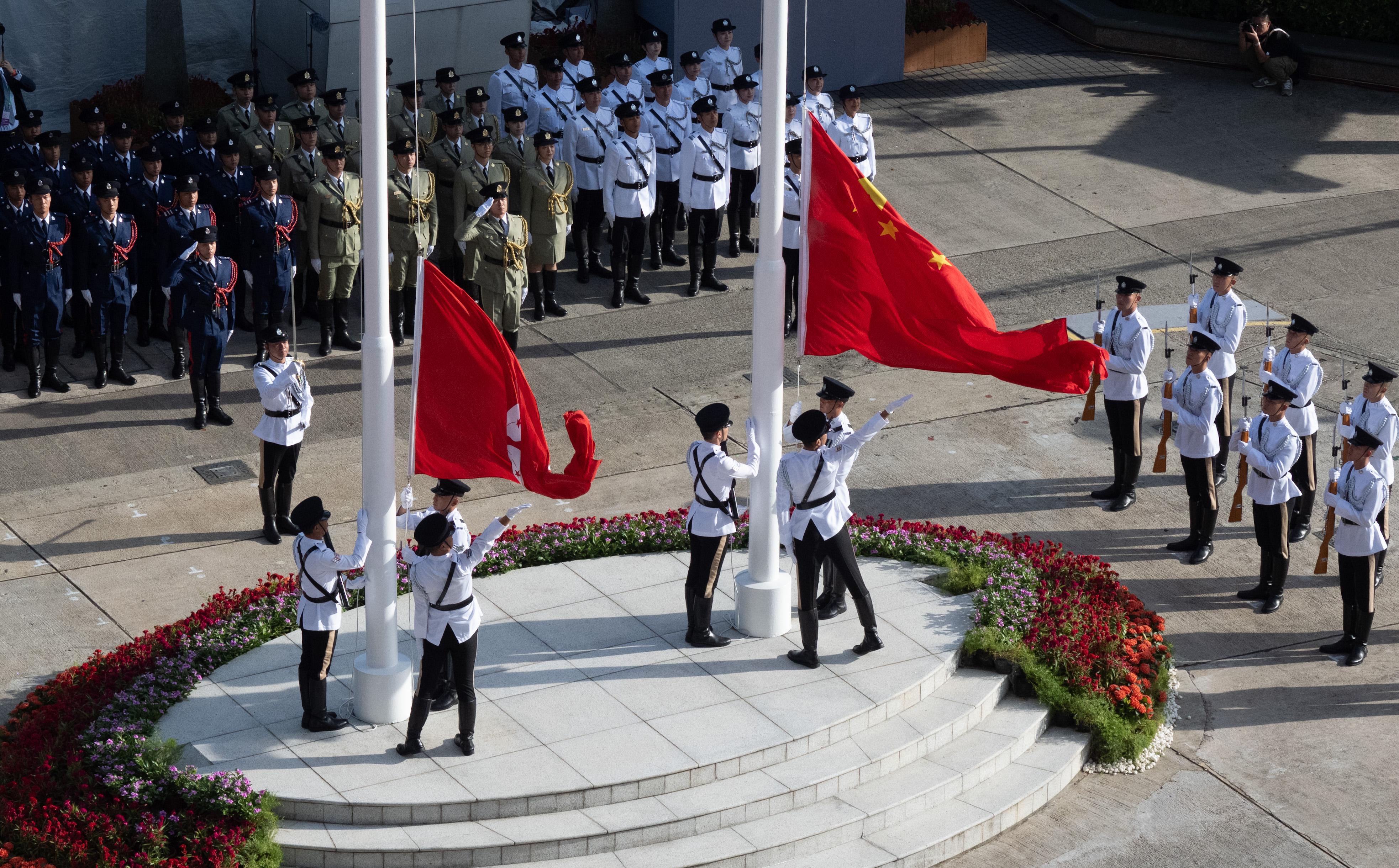 The Chief Executive, Mr John Lee, together with Principal Officials and guests, attends the flag-raising ceremony for the 75th anniversary of the founding of the People's Republic of China at Golden Bauhinia Square in Wan Chai this morning (October 1).