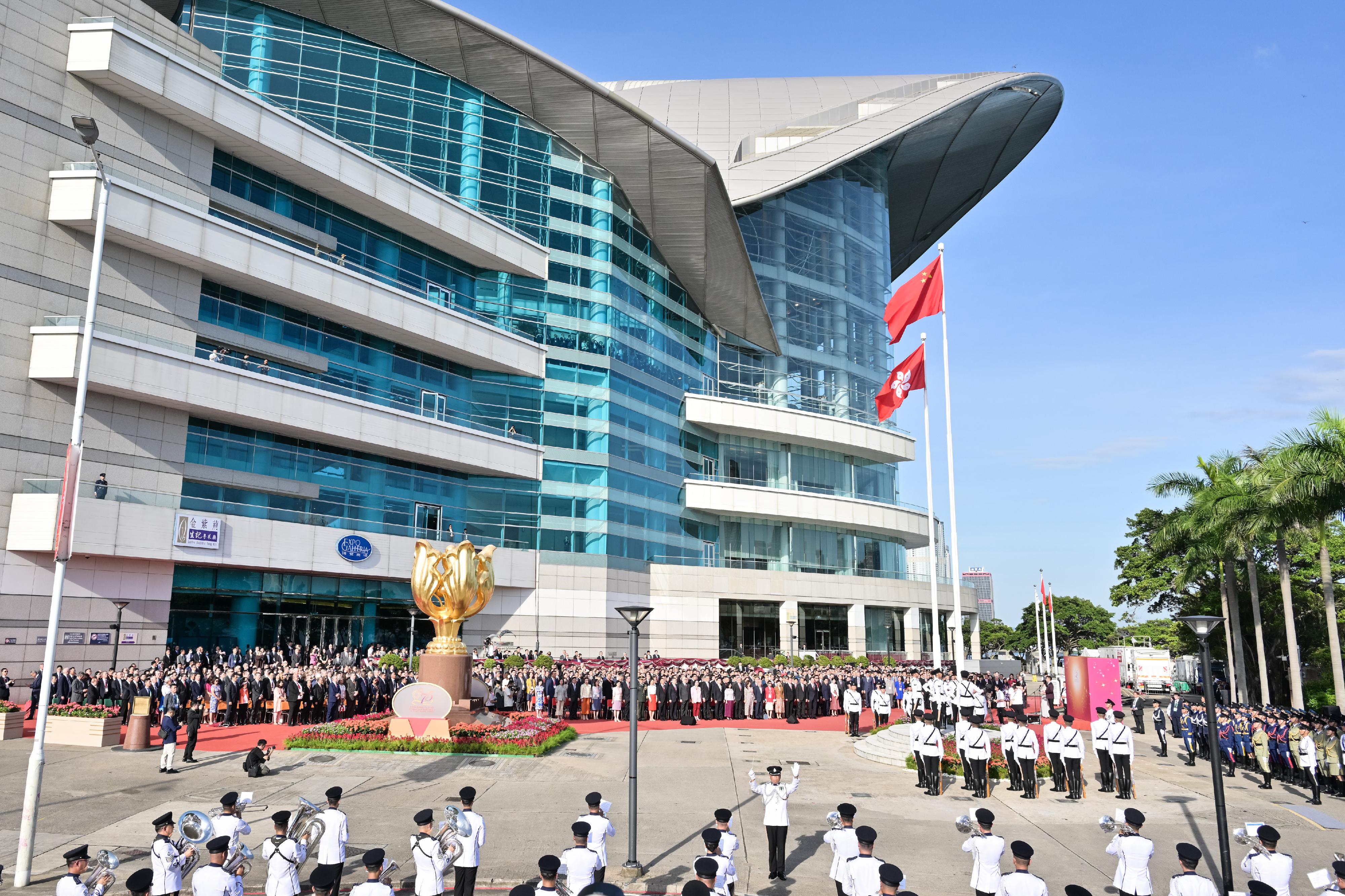 The Chief Executive, Mr John Lee, together with Principal Officials and guests, attends the flag-raising ceremony for the 75th anniversary of the founding of the People's Republic of China at Golden Bauhinia Square in Wan Chai this morning (October 1).