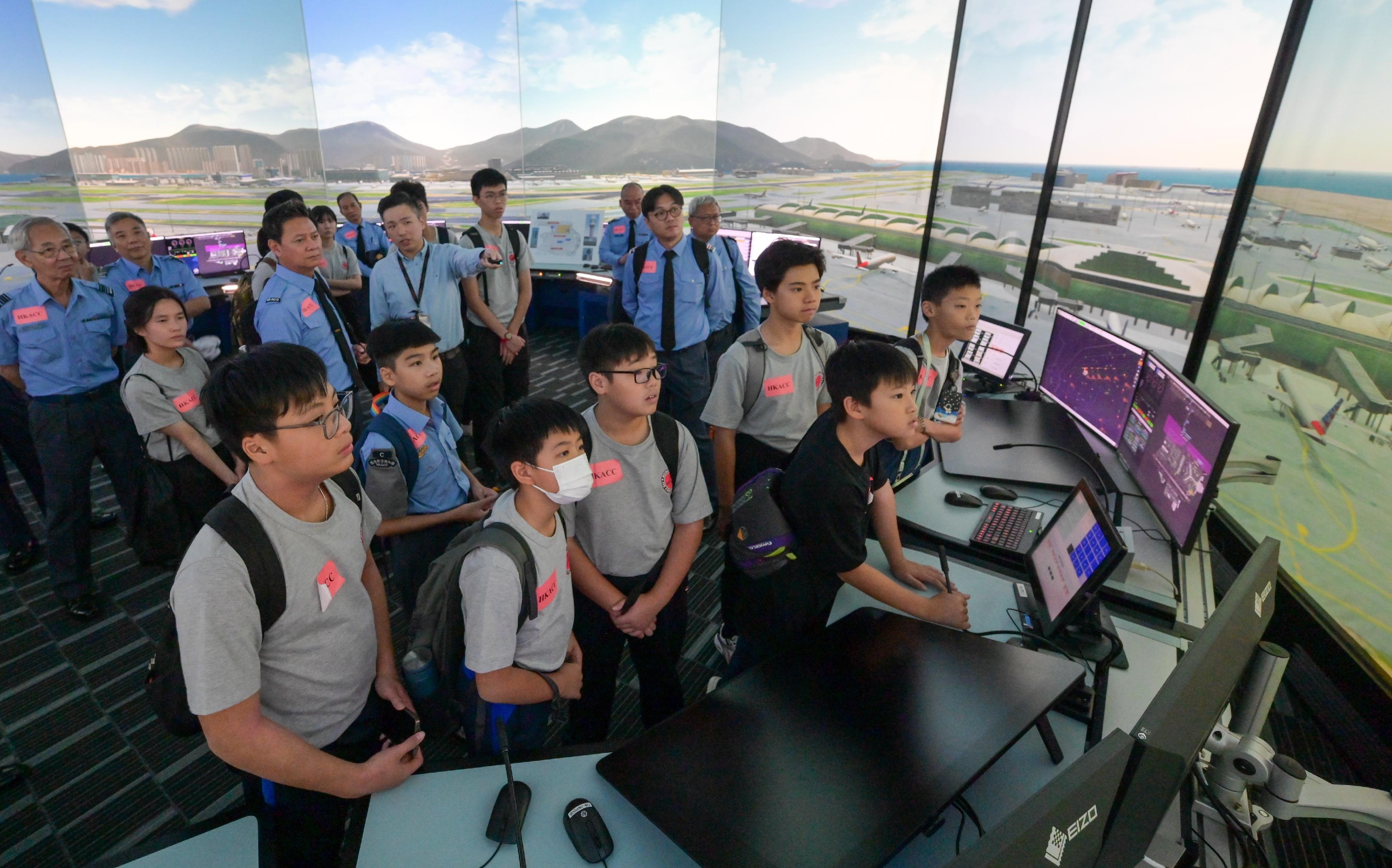 The Civil Aviation Department (CAD) held an aviation-themed youth activity at its headquarters today (October 5), to celebrate the 75th Anniversary of the founding of the People's Republic of China and enhance young people’s understanding of the aviation development in Hong Kong. Photo shows young people participating in the demonstration session of air traffic control tower simulator.