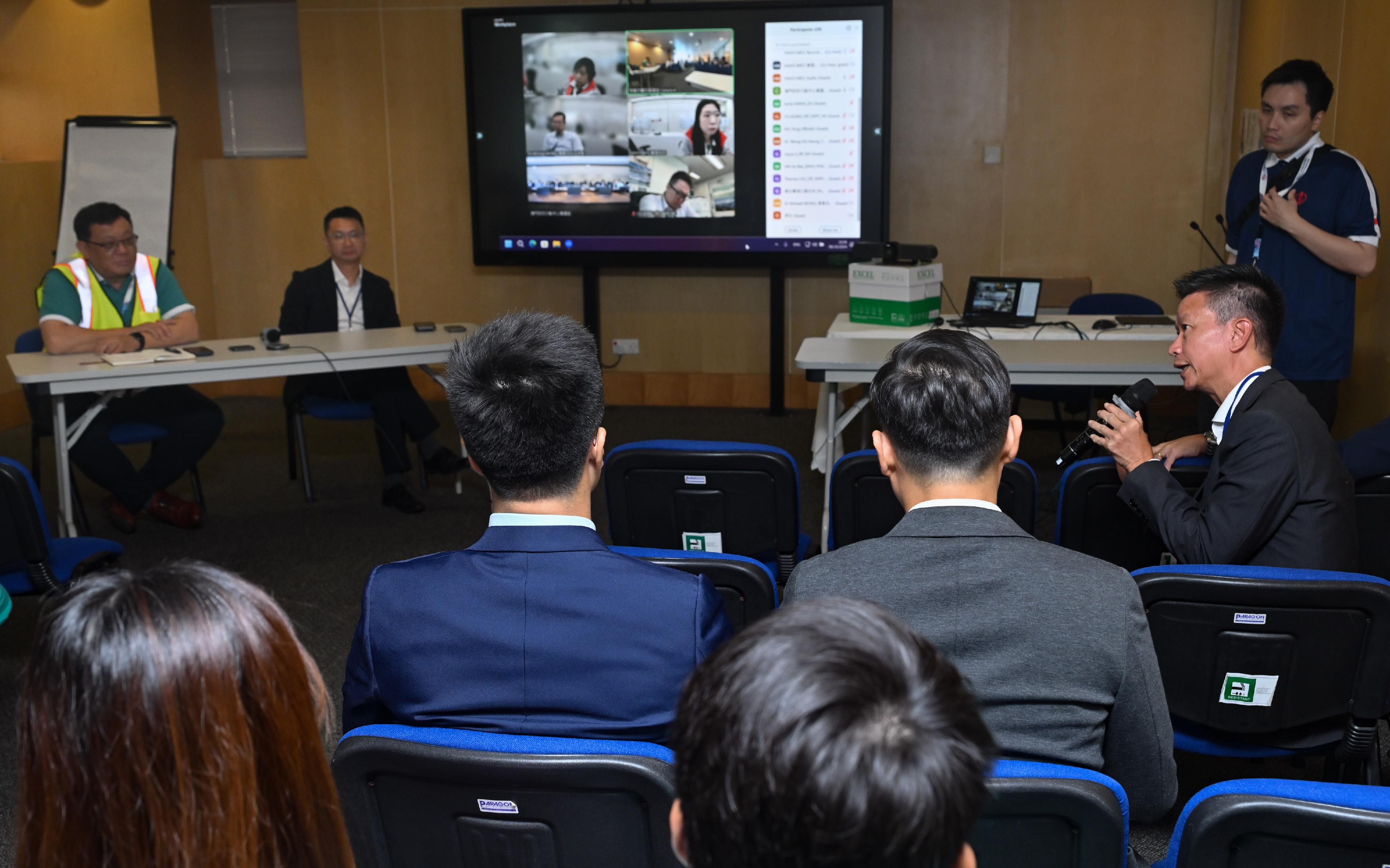 The Hong Kong Special Administrative Region Government, in collaboration with the Macao Special Administrative Region Government, conducted a drill for the Pilot Scheme for Direct Cross-boundary Ambulance Transfer in the Greater Bay Area today (October 8). Photo shows Deputy Secretary for Health Mr Sam Hui (second right) and participating personnel having a preliminary review on the drill today.