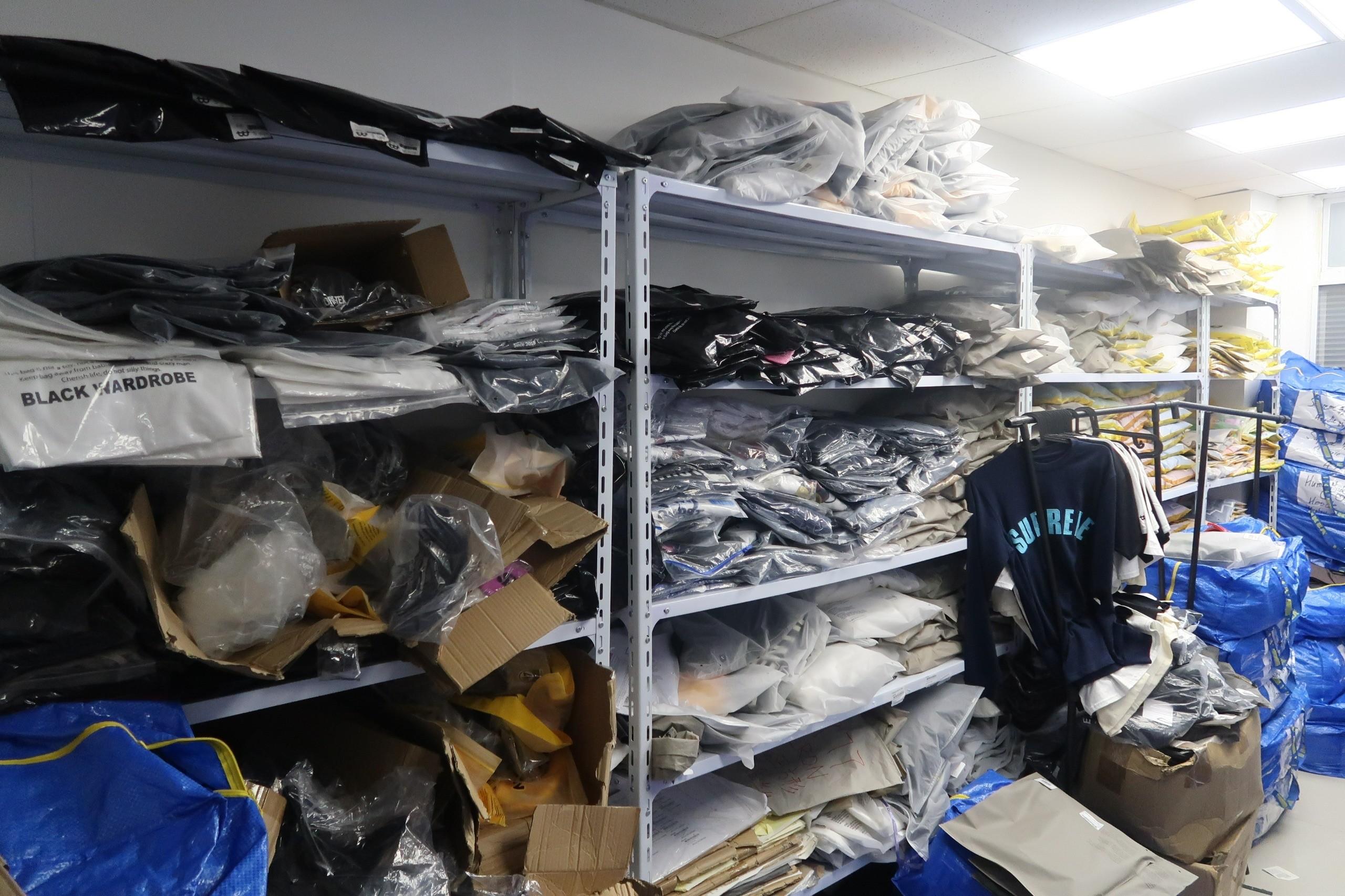 Hong Kong Customs conducted a special operation across shopping spots in Mong Kok on October 3 and yesterday (October 9) to combat the sale of counterfeit goods, seizing about 1 100 suspected counterfeit clothes and sneakers with an estimated market value of about $820,000. Photo shows a storage facility suspected to be used for storing counterfeit clothing.