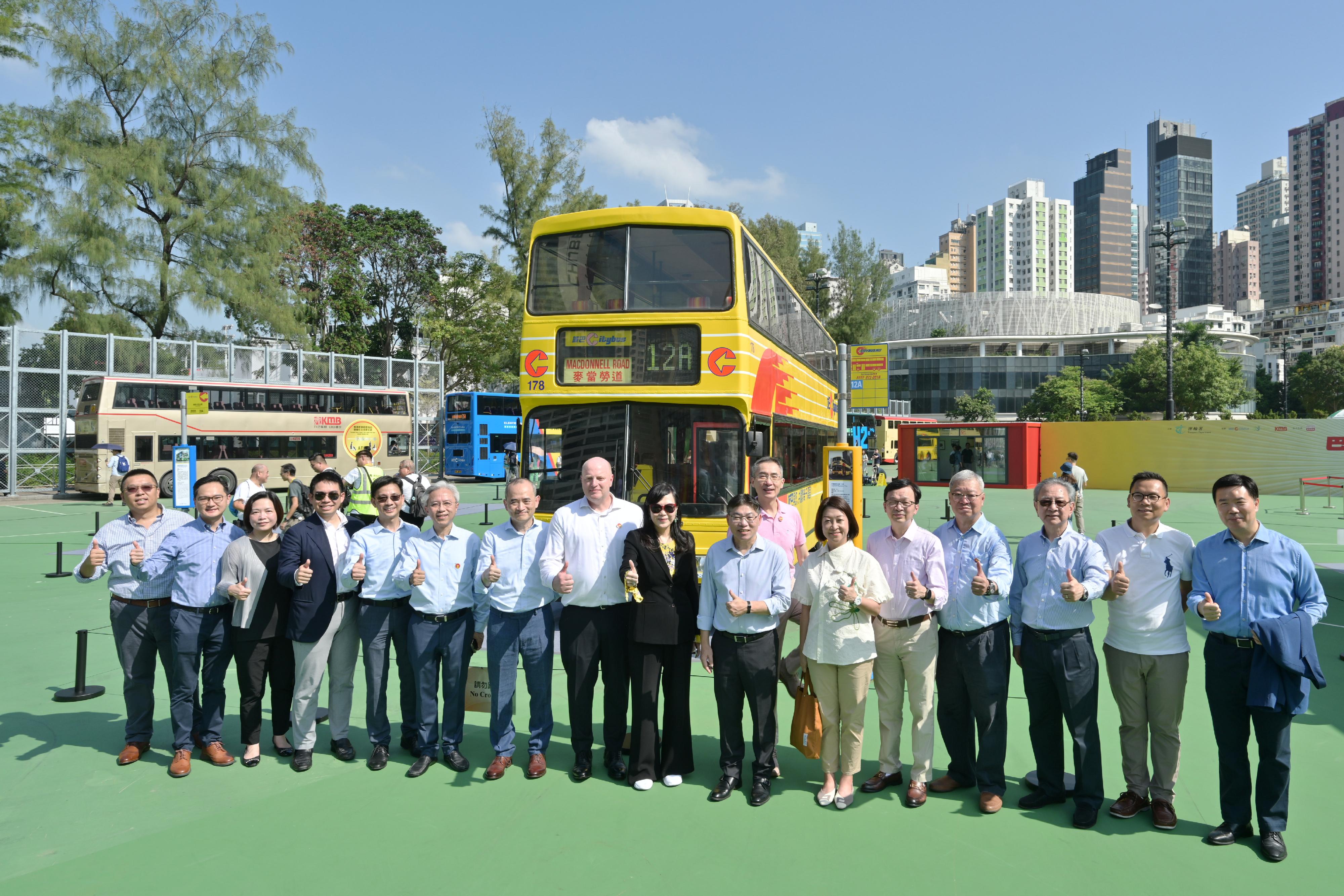 The Secretary for Transport and Logistics, Mr Lam Sai-hung, today (October 19) visited the Bus Exhibition for Celebrating the 75th Anniversary of the Founding of the People's Republic of China organised by the Transport Department. It is one of the highlight events amid National Day celebrations this year. Photo shows (front row, from tenth left) Mr Lam; the Commissioner for Transport, Ms Angela Lee; the Under Secretary for Transport and Logistics, Mr Liu Chun-san; and guests at the Citybus exhibition area.