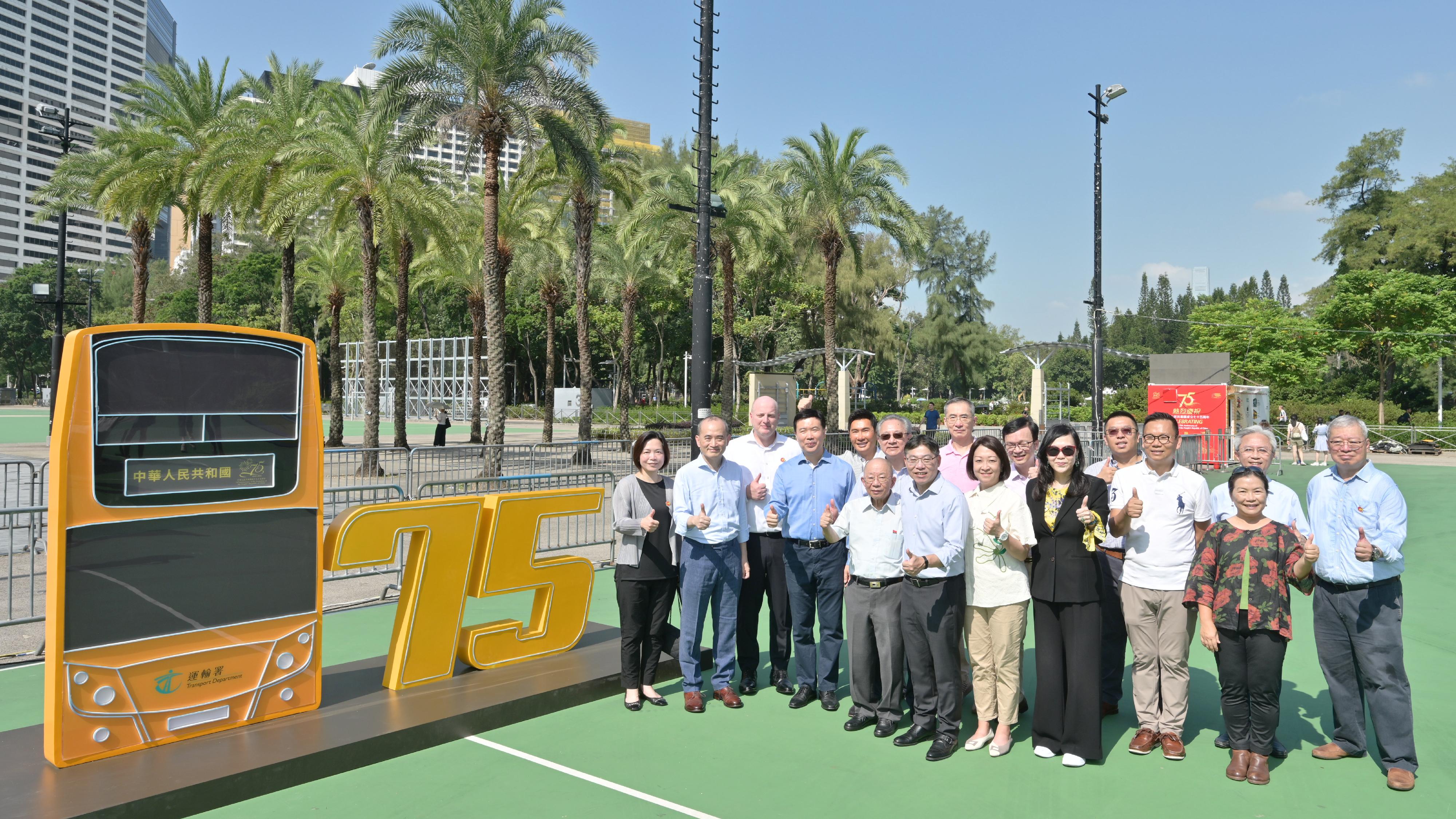 The Secretary for Transport and Logistics, Mr Lam Sai-hung, today (October 19) visited the Bus Exhibition for Celebrating the 75th Anniversary of the Founding of the People's Republic of China organised by the Transport Department. It is one of the highlight events amid National Day celebrations this year. Photo shows Mr Lam (front row, fifth right) ; the Commissioner for Transport, Ms Angela Lee (front row, fourth right); the Under Secretary for Transport and Logistics, Mr Liu Chun-san (back row, fourth right); and guests at the neon light installation.