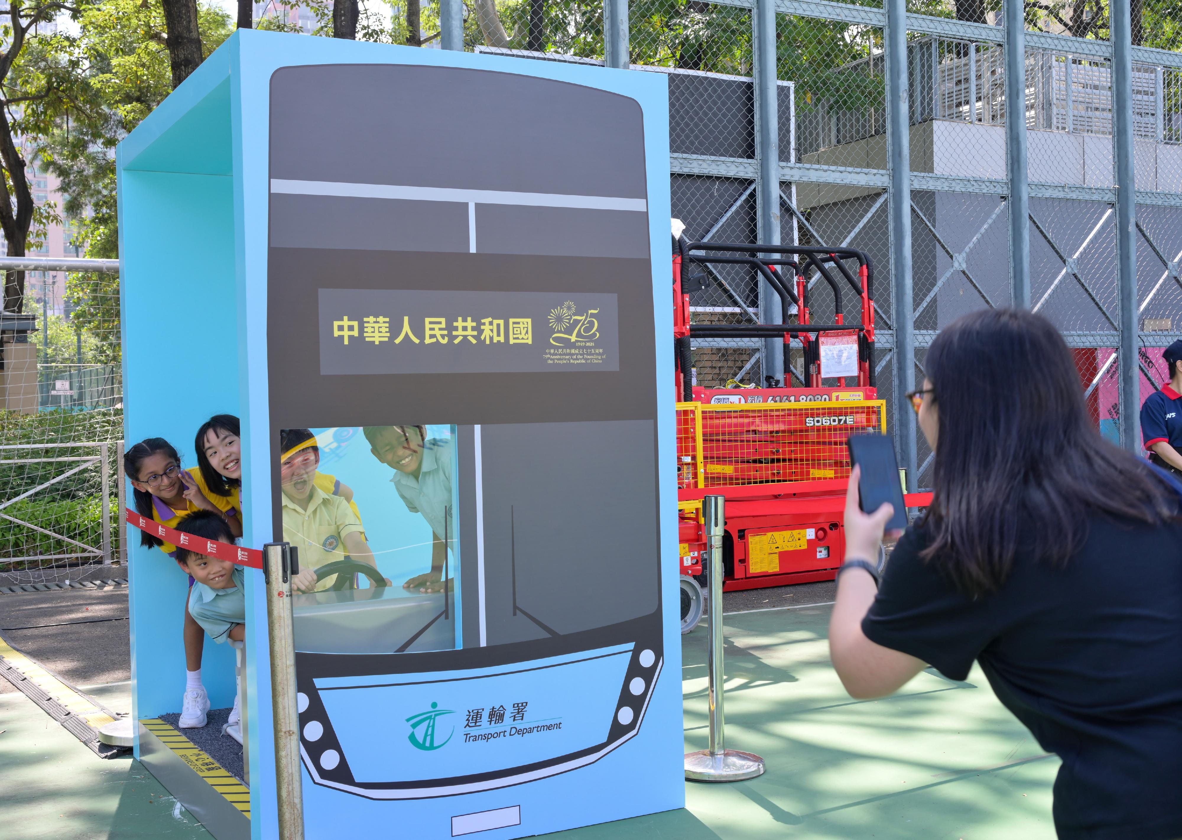 Organised by the Transport Department, the four-day Bus Exhibition for Celebrating the 75th Anniversary of the Founding of the People's Republic of China was launched today (October 19) in Victoria Park in Causeway Bay. It is one of the highlight events held by the Hong Kong Special Administrative Region Government amid National Day celebrations this year. Photo shows a photo-taking spot simulating a bus driver.