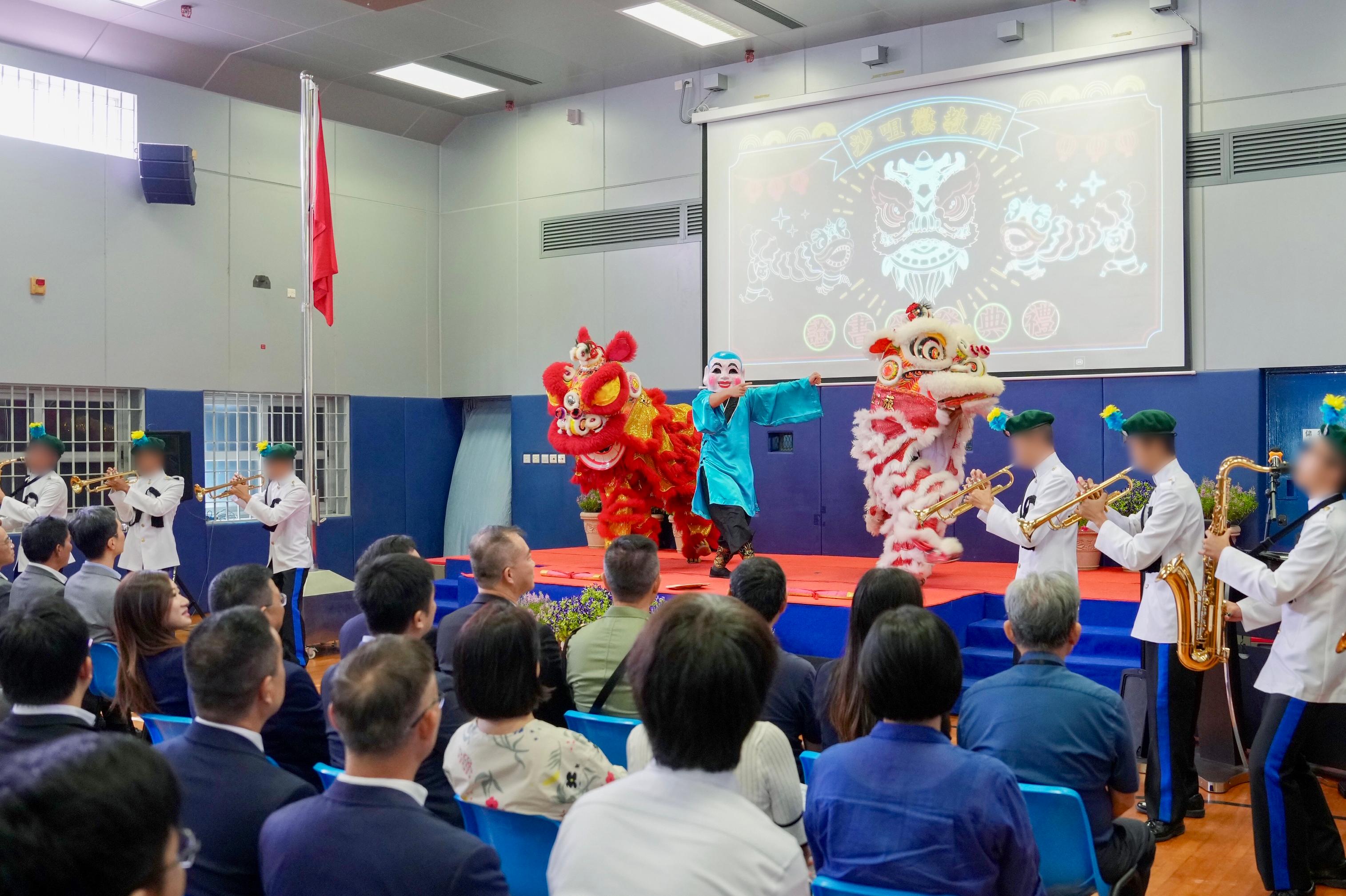 Young persons in custody at Sha Tsui Correctional Institution of the Correctional Services Department were presented with certificates at a ceremony today (October 23) in recognition of their efforts and achievements in studies and vocational examinations. Photo shows a lion dance performance by young persons in custody with accompaniment by a marching band.