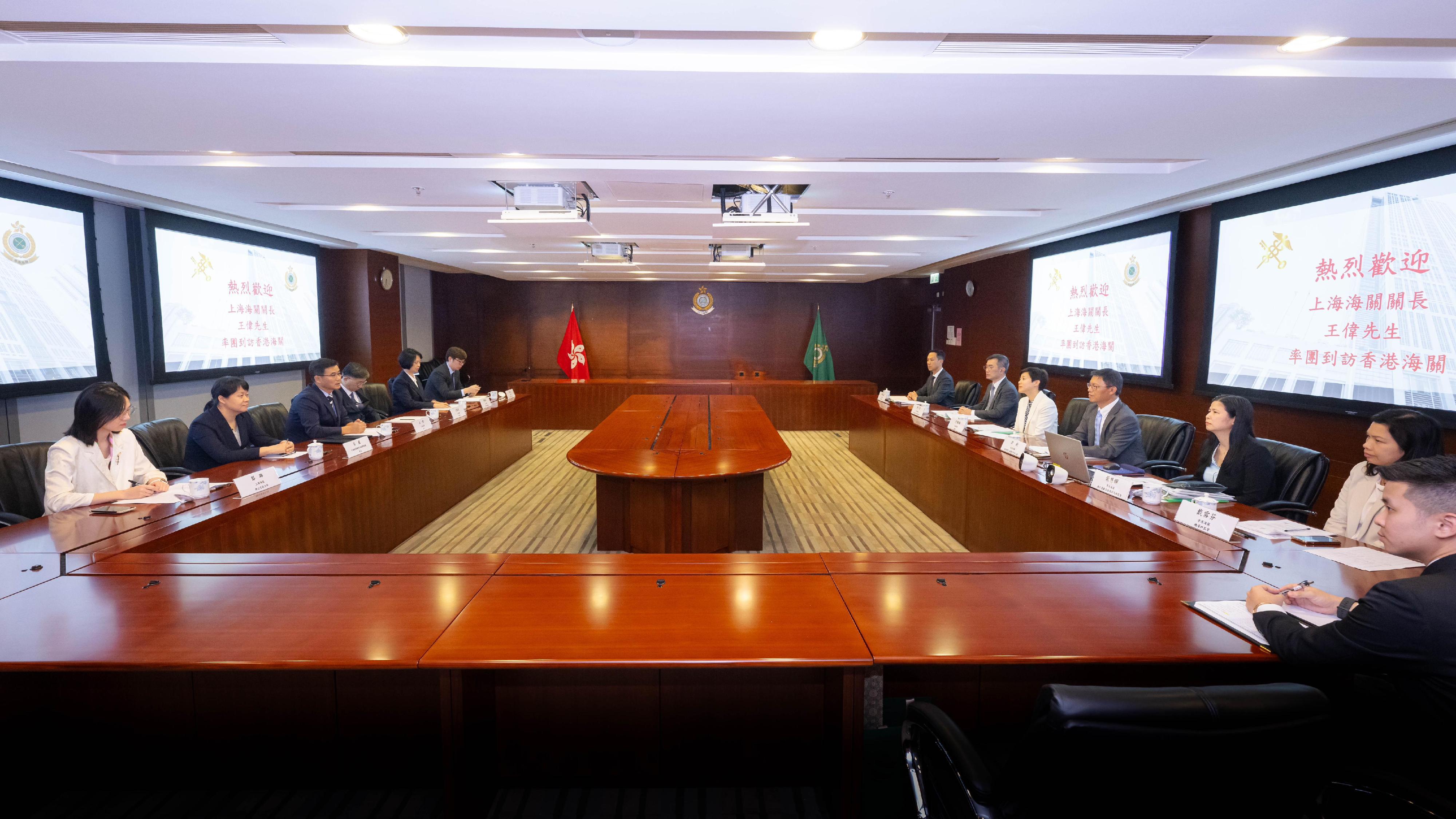 The Commissioner of Customs and Excise, Ms Louise Ho (fifth right), today (October 23) met with the Director General in Shanghai Customs District, Mr Wang Wei (third left), in the Customs Headquarters Building to exchange views on expediting the development of Smart Customs and deepening co-operation in risk management. Photos shows officers from both Customs administrations in a meeting.