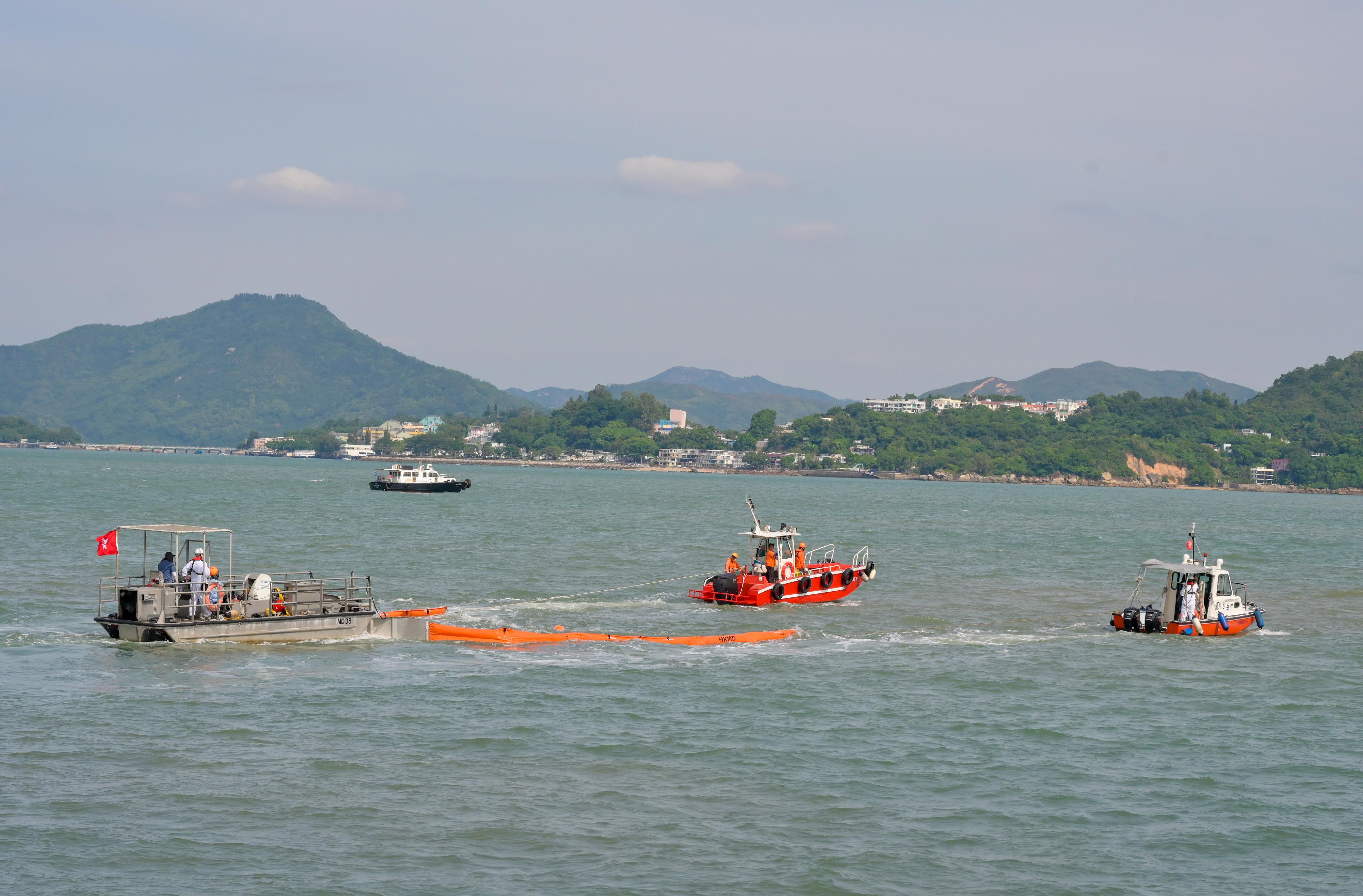 The annual marine pollution joint response exercises, code-named Oilex 2024 and Maritime Hazardous and Noxious Substances (HNS) 2024, were conducted by various government departments this morning (October 23) in the waters off Sunshine Island to test their marine pollution responses in the event of a spillage of oil and HNS in Hong Kong waters. Photo shows an oil pollution combat team deploying floating booms as barrier to prevent the spill from spreading.