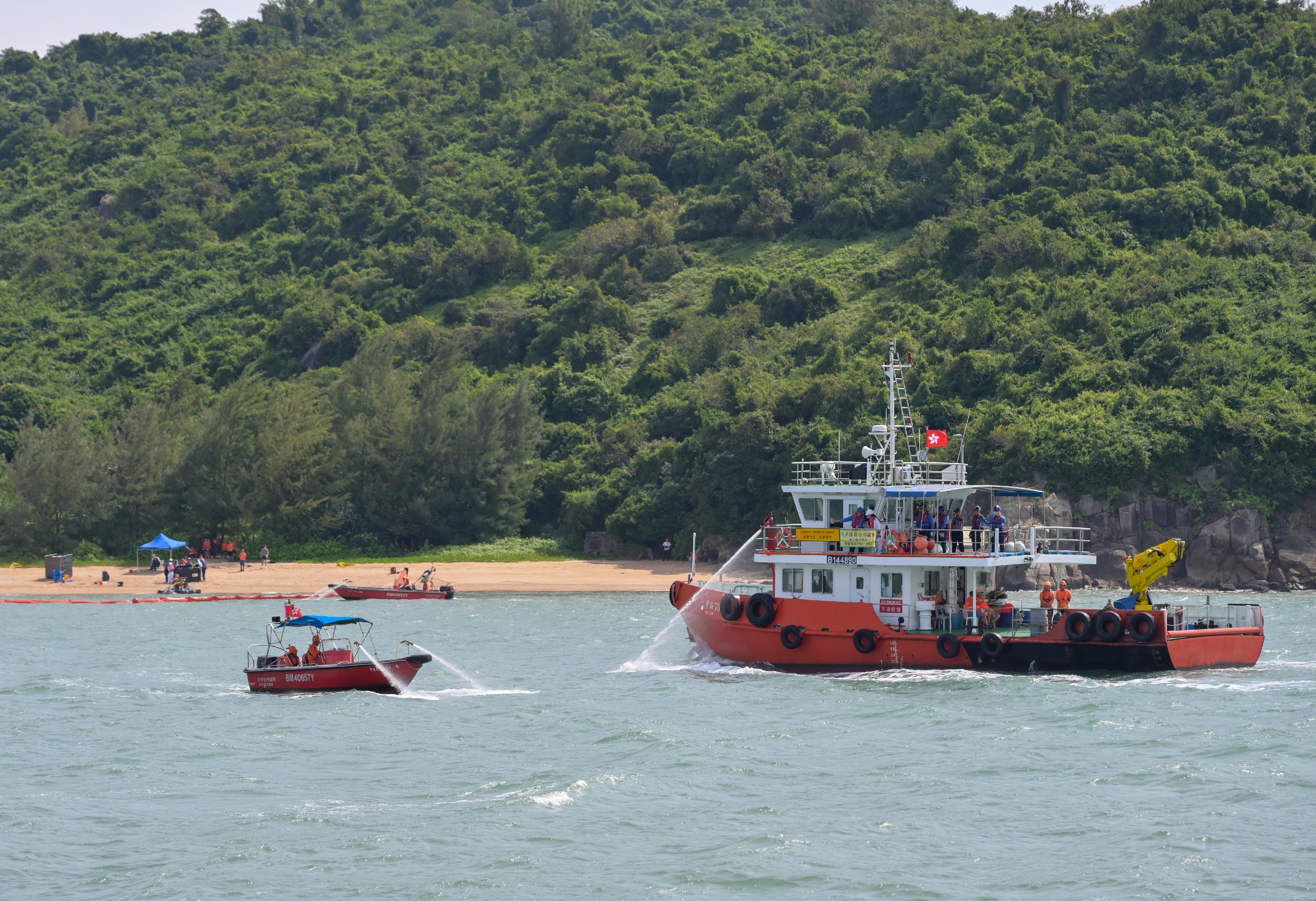 The annual marine pollution joint response exercises, code-named Oilex 2024 and Maritime Hazardous and Noxious Substances (HNS) 2024, were conducted by various government departments this morning (October 23) in the waters off Sunshine Island to test their marine pollution responses in the event of a spillage of oil and HNS in Hong Kong waters. Photo shows a pollution control vessel simulating the spraying of oil dispersant with water.