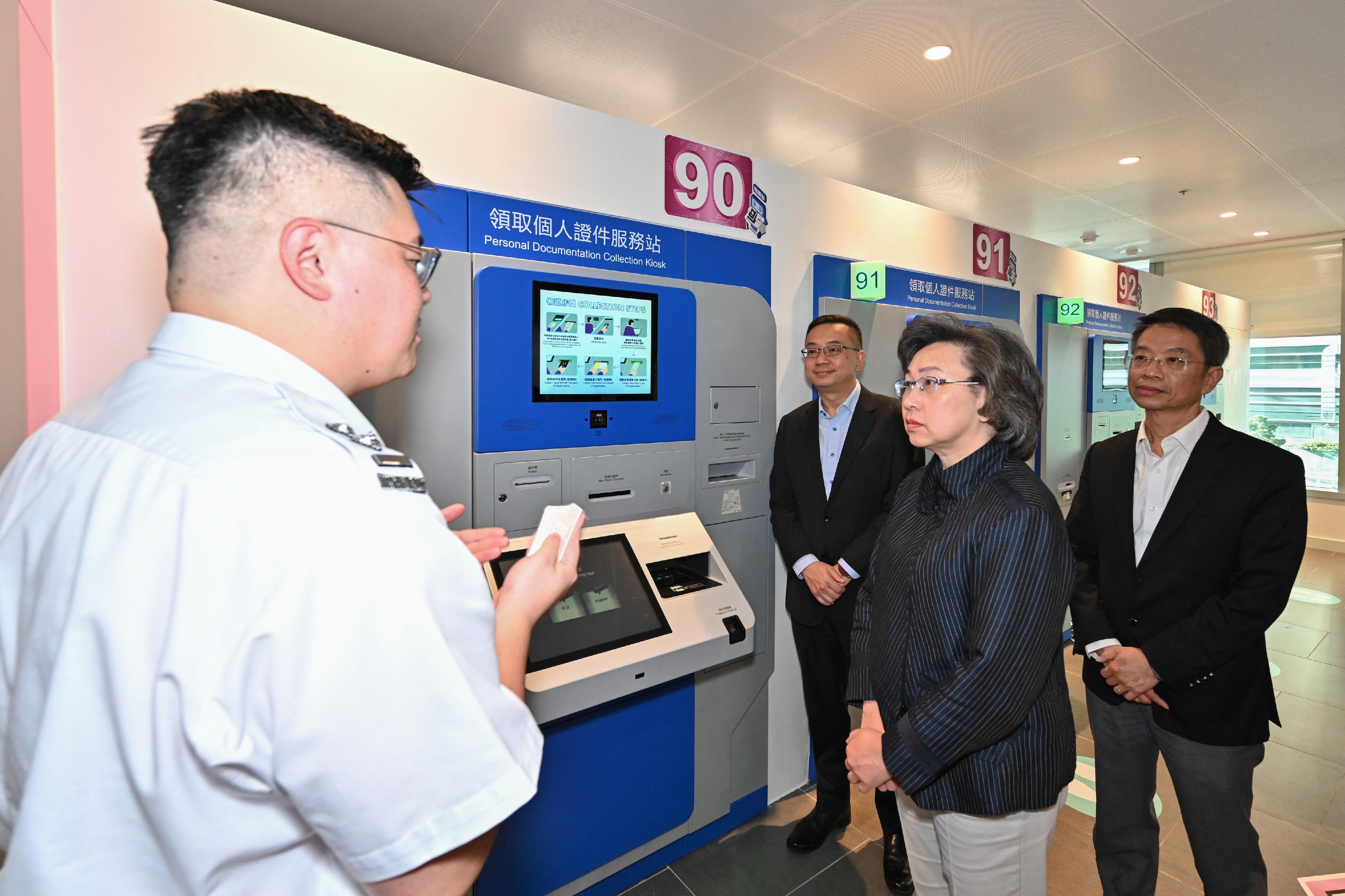 The Secretary for the Civil Service, Mrs Ingrid Yeung, visited the new headquarters of the Immigration Department (ImmD) in Tseung Kwan O today (October 24). Photo shows Mrs Yeung (second right) visiting the Registration of Persons Office where ImmD staff briefed her on her the Personal Documentation Collection Kiosks. Looking on are the Permanent Secretary for the Civil Service, Mr Clement Leung (first right), and the Director of Immigration, Mr Benson Kwok (third right).