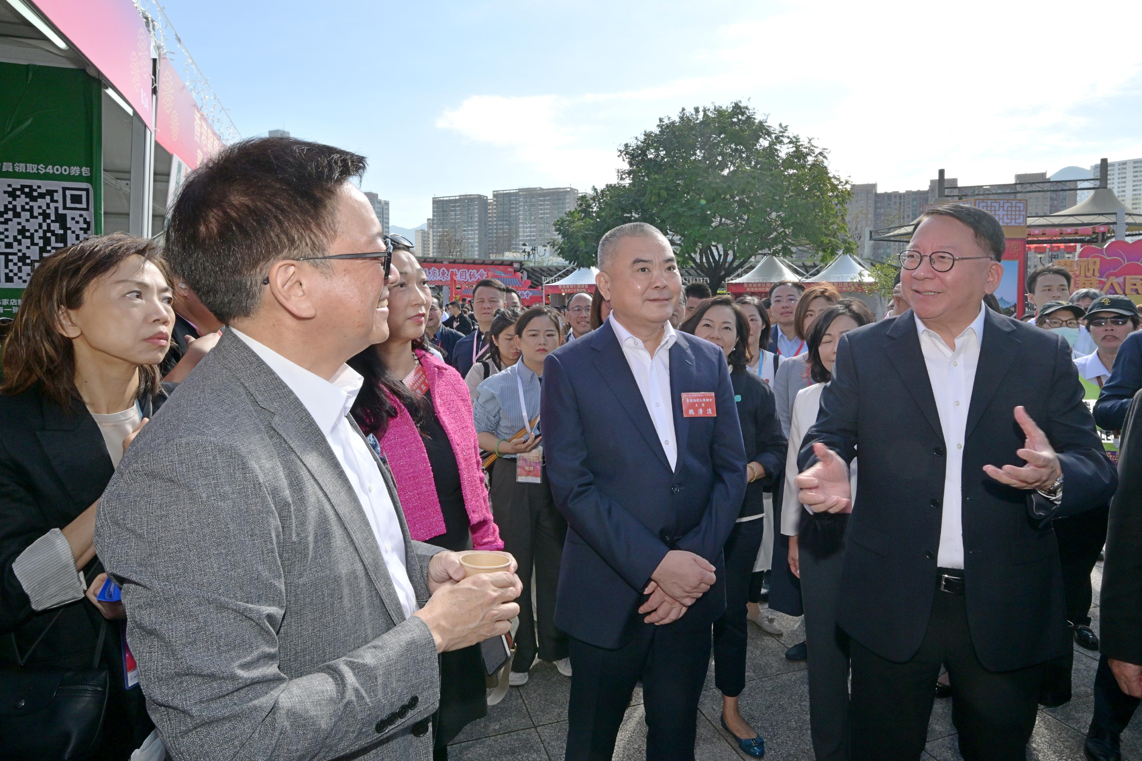 The Chief Secretary for Administration, Mr Chan Kwok-ki, attended the opening ceremony of the Bazaar Carnival in Celebration of the 75th Anniversary of the Founding of the People's Republic of China today (October 25). Photo shows Mr Chan (first right) touring the Bazaar Carnival.