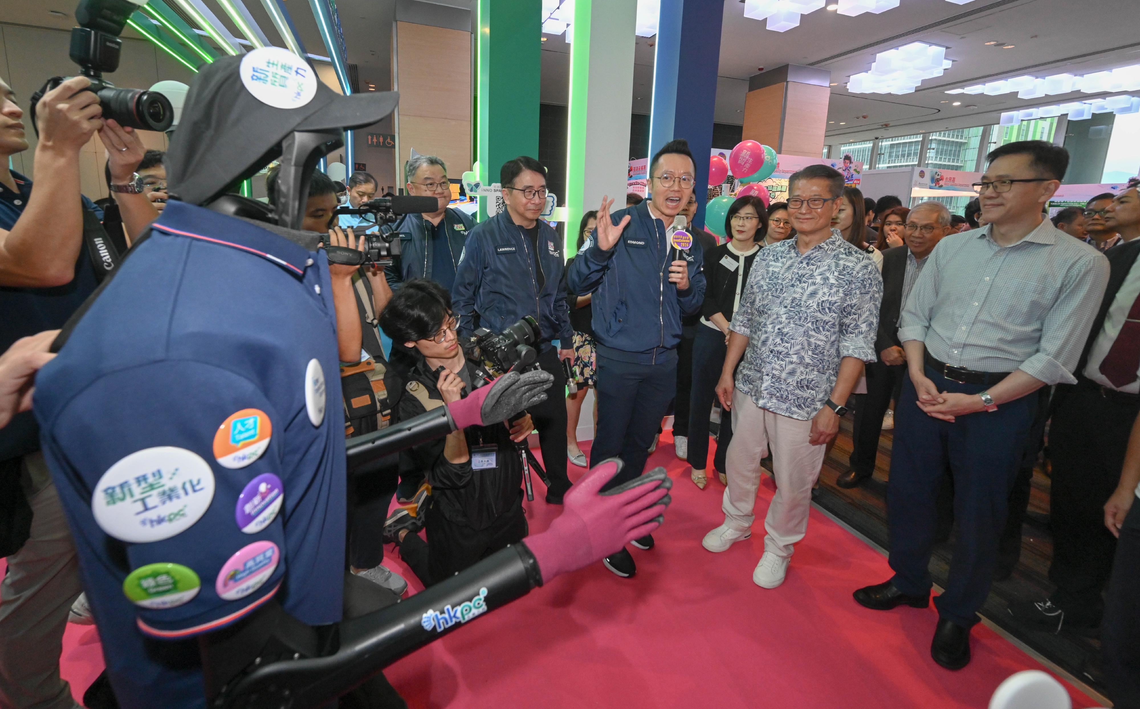 The Financial Secretary, Mr Paul Chan, attended the opening ceremony of InnoCarnival 2024 today (October 26). Photo shows Mr Chan (second right), accompanied by the Secretary for Innovation, Technology and Industry, Professor Sun Dong (first right), visiting an exhibition booth of the Hong Kong Productivity Council.
