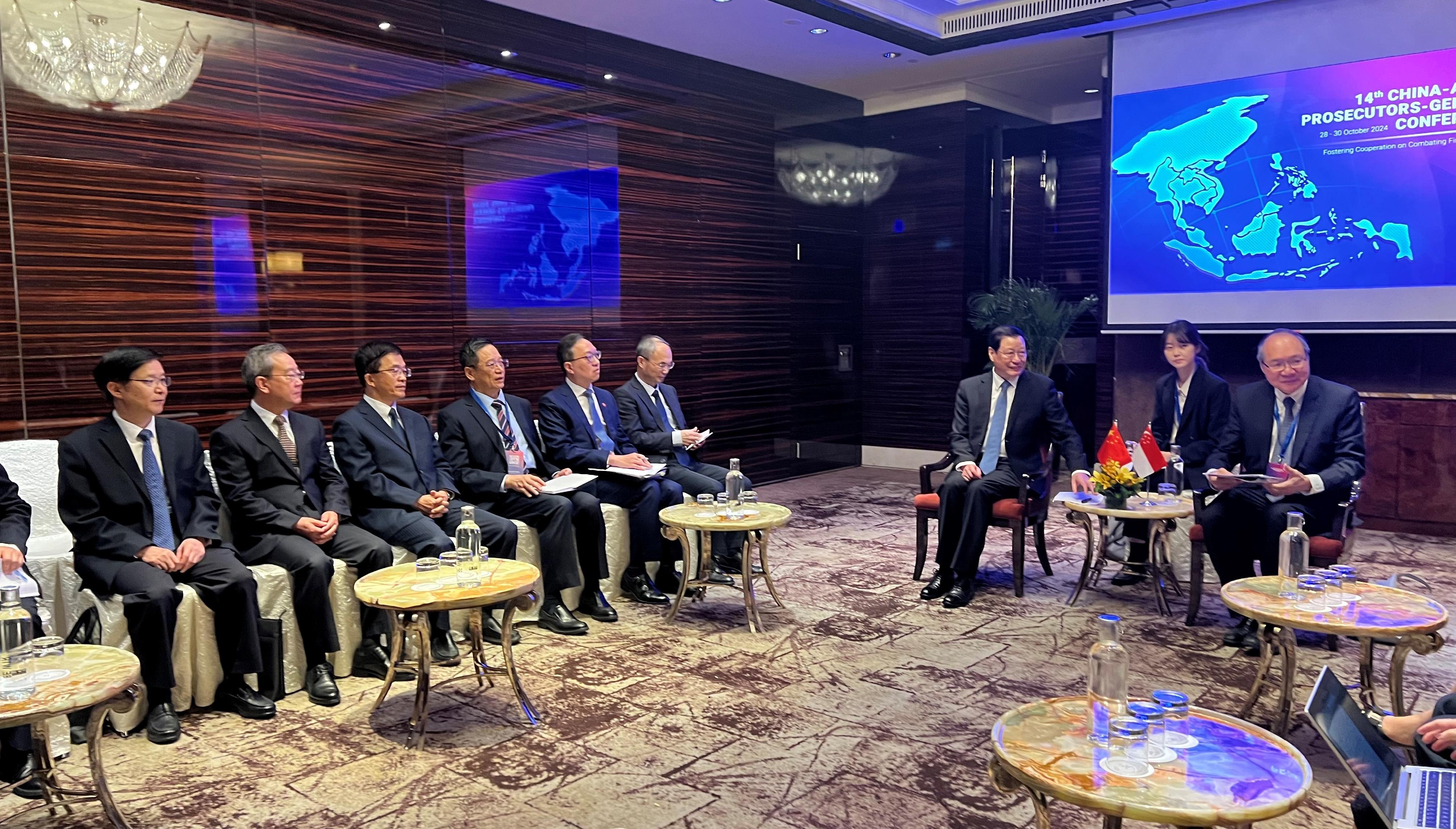 The Secretary for Justice, Mr Paul Lam, SC, as a member of the Chinese delegation, attended bilateral meetings between the delegation and member states of Association of Southeast Asian Nations, to exchange views with them on issues of mutual interest in Singapore on October 28. Photo shows Mr Lam (fifth left); the Prosecutor-General of the Supreme People's Procuratorate, Mr Ying Yong (seventh left); the Ambassador Extraordinary and Plenipotentiary of the People's Republic of China to the Republic of Singapore, Mr Cao Zhongming (sixth left); and other members of the Chinese delegation attending the bilateral meeting with the Attorney-General of Singapore, Mr Lucien Wong (first right).