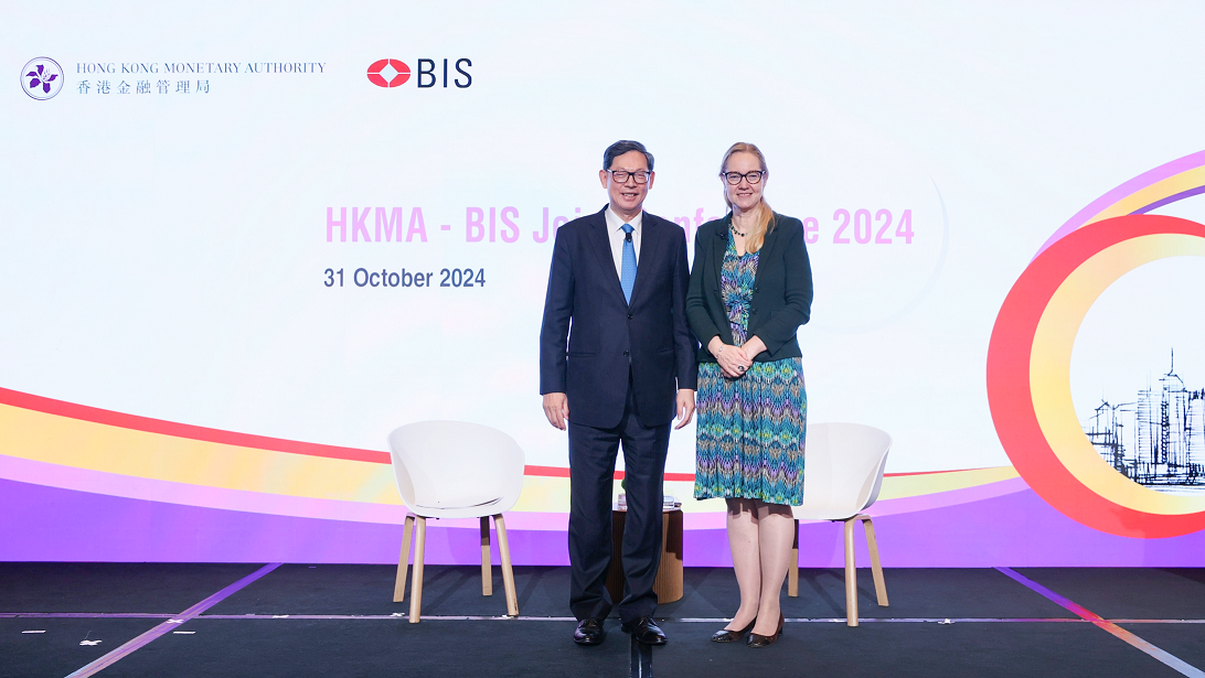 Senior Advisor of the Hong Kong Academy of Finance and former Chief Executive of the Hong Kong Monetary Authority Mr Norman Chan (left) moderates a fireside chat titled "Artificial intelligence and implications for central banks" with the Head of Bank for International Settlements Innovation Hub, Ms Cecilia Skingsley (right), at the HKMA-BIS Joint Conference 2024 today (October 31).