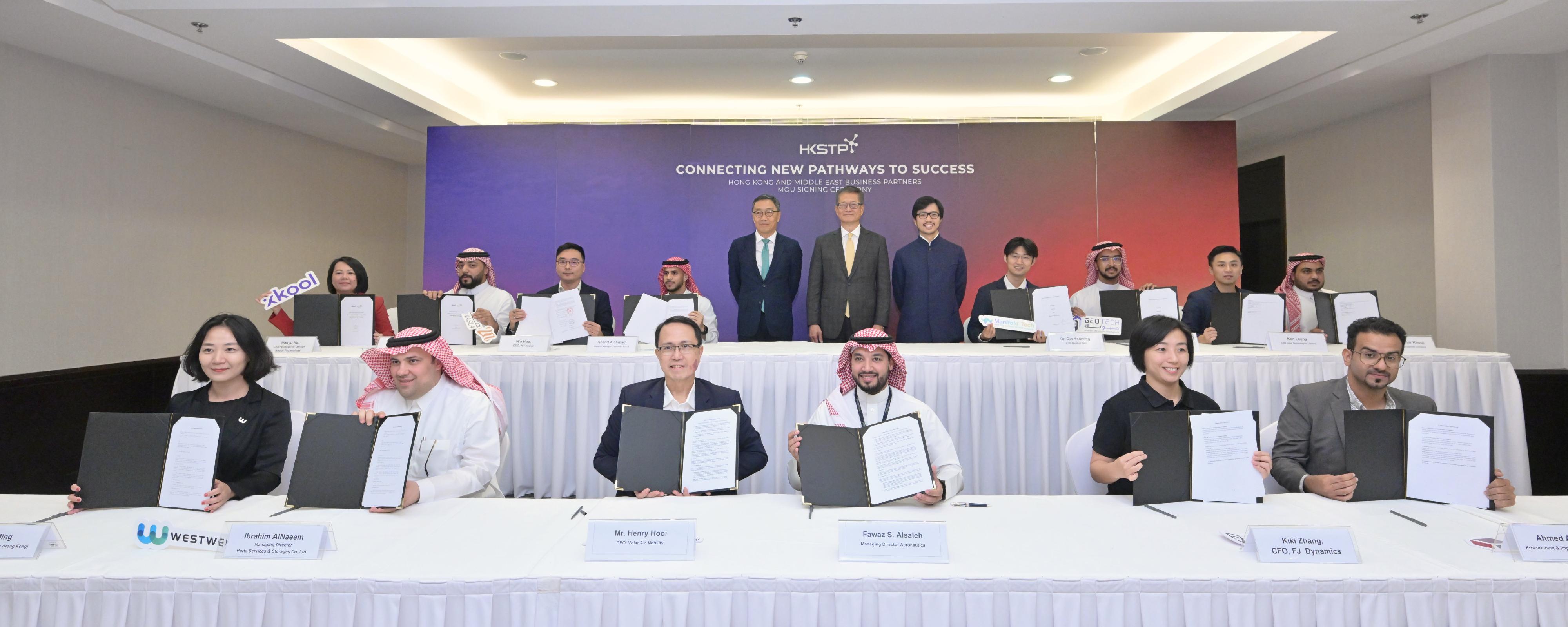 The Financial Secretary, Mr Paul Chan, continued to lead a delegation visiting Riyadh, Saudi Arabia, yesterday (October 31, Riyadh time). Photo shows Mr Chan (back row, centre), the Commissioner for the Belt and Road Mr Nicholas Ho (back row, fifth right), and the Chief Executive Officer of Hong Kong Science and Technology Parks  Corporation, Mr Albert Wong (back row, fifth left), witnessing the signing of memoranda of understanding between seven start-ups from the Hong Kong Science Park and Middle East enterprises and institutions.