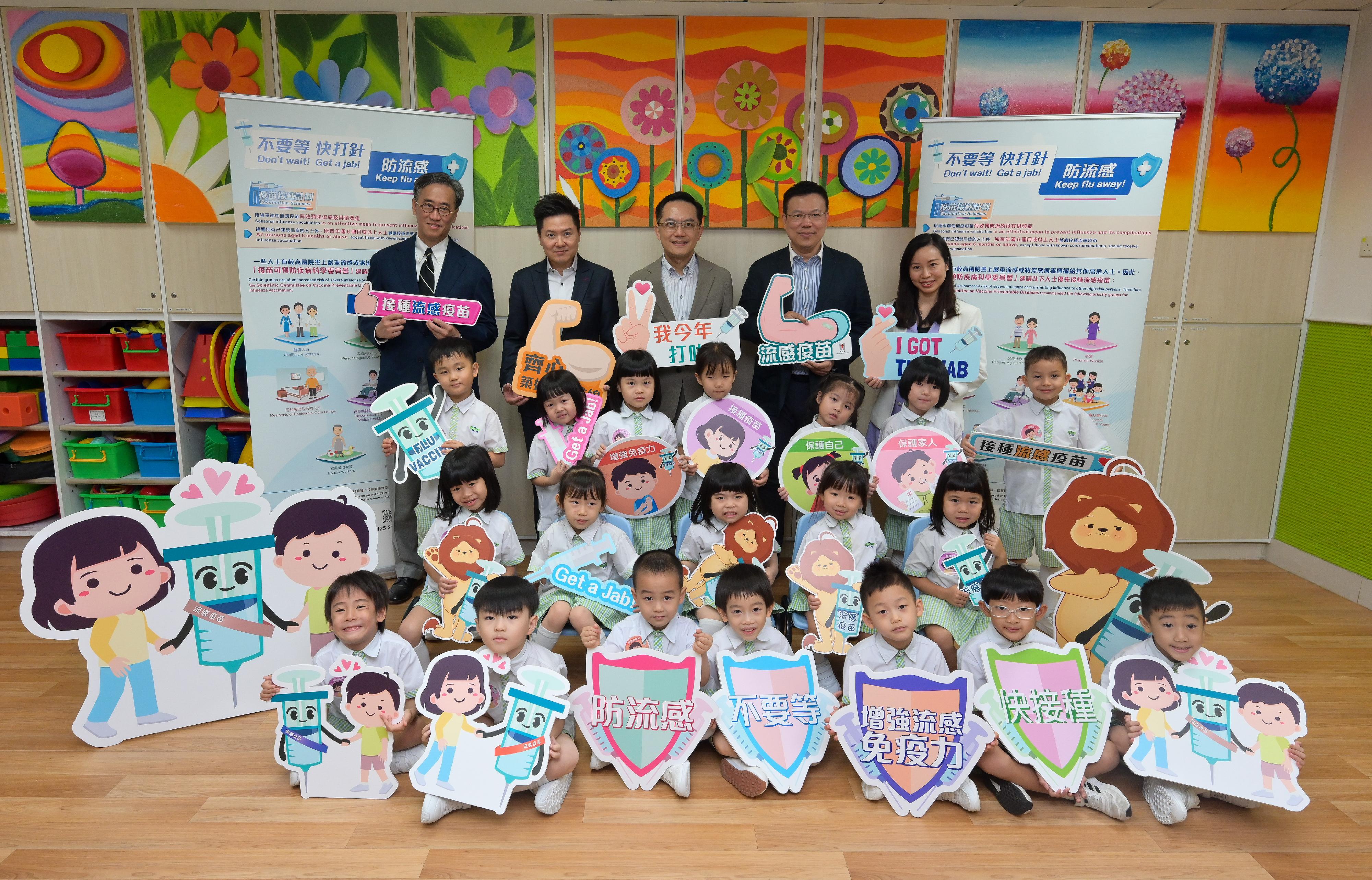 The Director of Health, Dr Ronald Lam, and the Controller of the Centre for Health Protection of the Department of Health, Dr Edwin Tsui, visited Hong Kong Young Women's Christian Association Tai Hon Fan Nursery School this morning (November 4) to view the implementation of the school outreach seasonal influenza vaccination service. Photo shows Dr Lam (fourth row, centre) and Dr Tsui (fourth row, second left) with teachers and students, as well as the visiting doctor who provides the vaccination service.