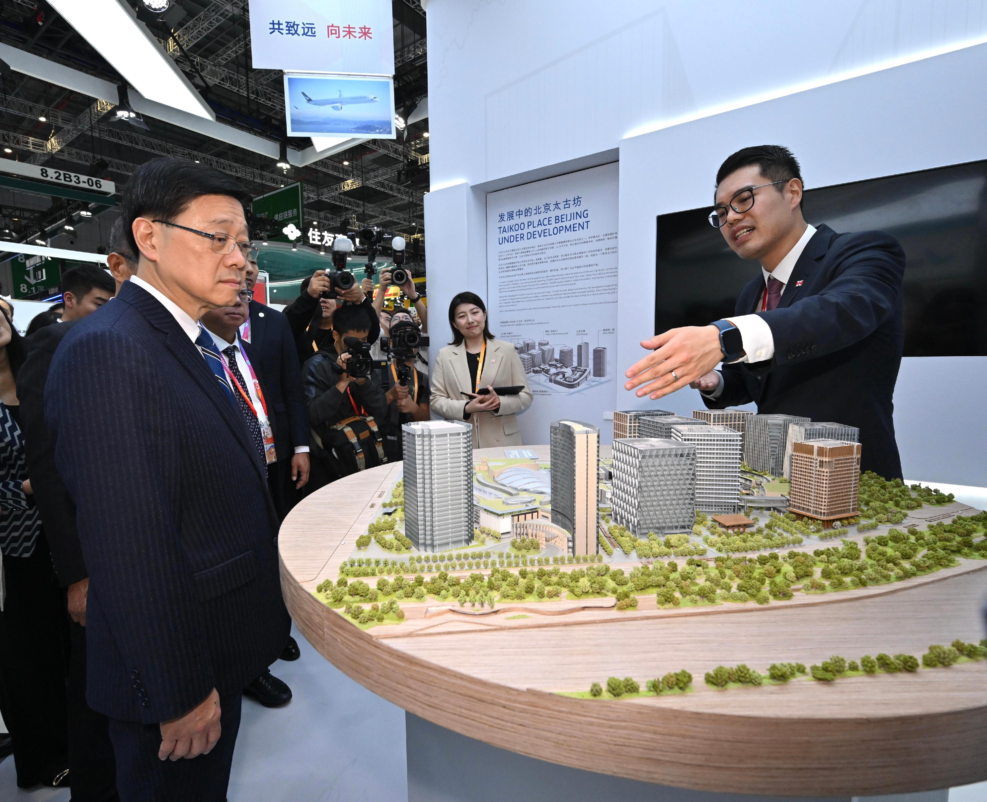 The Chief Executive, Mr John Lee, toured the seventh China International Import Expo in Shanghai today (November 5). Photo shows Mr Lee (left) visiting a pavilion of Hong Kong enterprises and interacting with exhibitors.