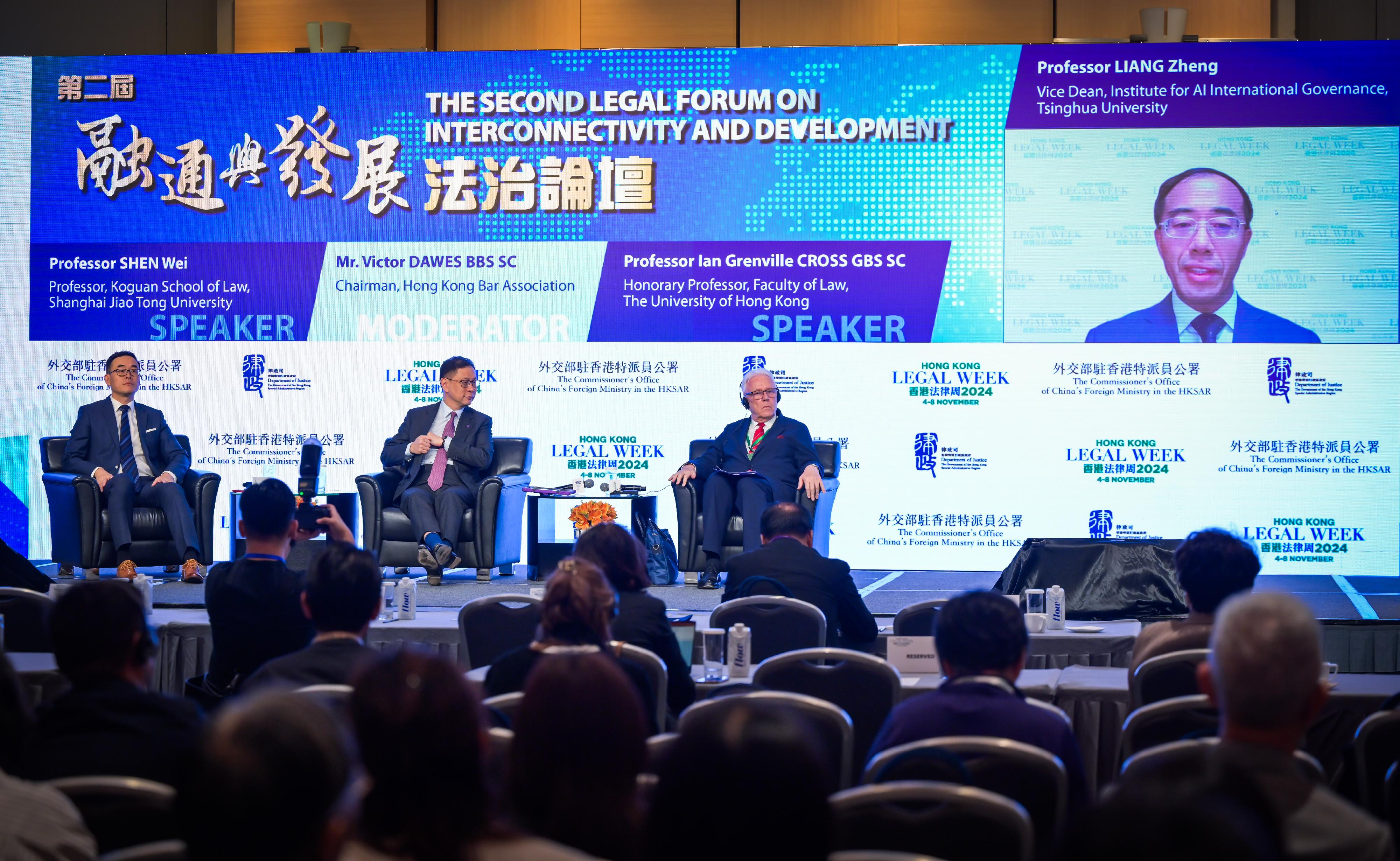 As part of Hong Kong Legal Week 2024, the Second Legal Forum on Interconnectivity and Development, co-organised by the Office of the Commissioner of the Ministry of Foreign Affairs in the Hong Kong Special Administrative Region and the Department of Justice, was held today (November 5). Photo shows (from left) Professor of Koguan School of Law of Shanghai Jiao Tong University Professor Shen Wei; the Chairperson of the Hong Kong Bar Association, Mr Victor Dawes, SC; Honorary Professor of the Faculty of Law of the University of Hong Kong Professor Grenville Cross, SC; and the Vice Dean of Institute for AI International Governance of Tsinghua University, Professor Liang Zheng (on screen), at Session  2 on Rule of Law as a Risk Management Mechanism to Safeguard Hong Kong’s and National Sustainable Development.
