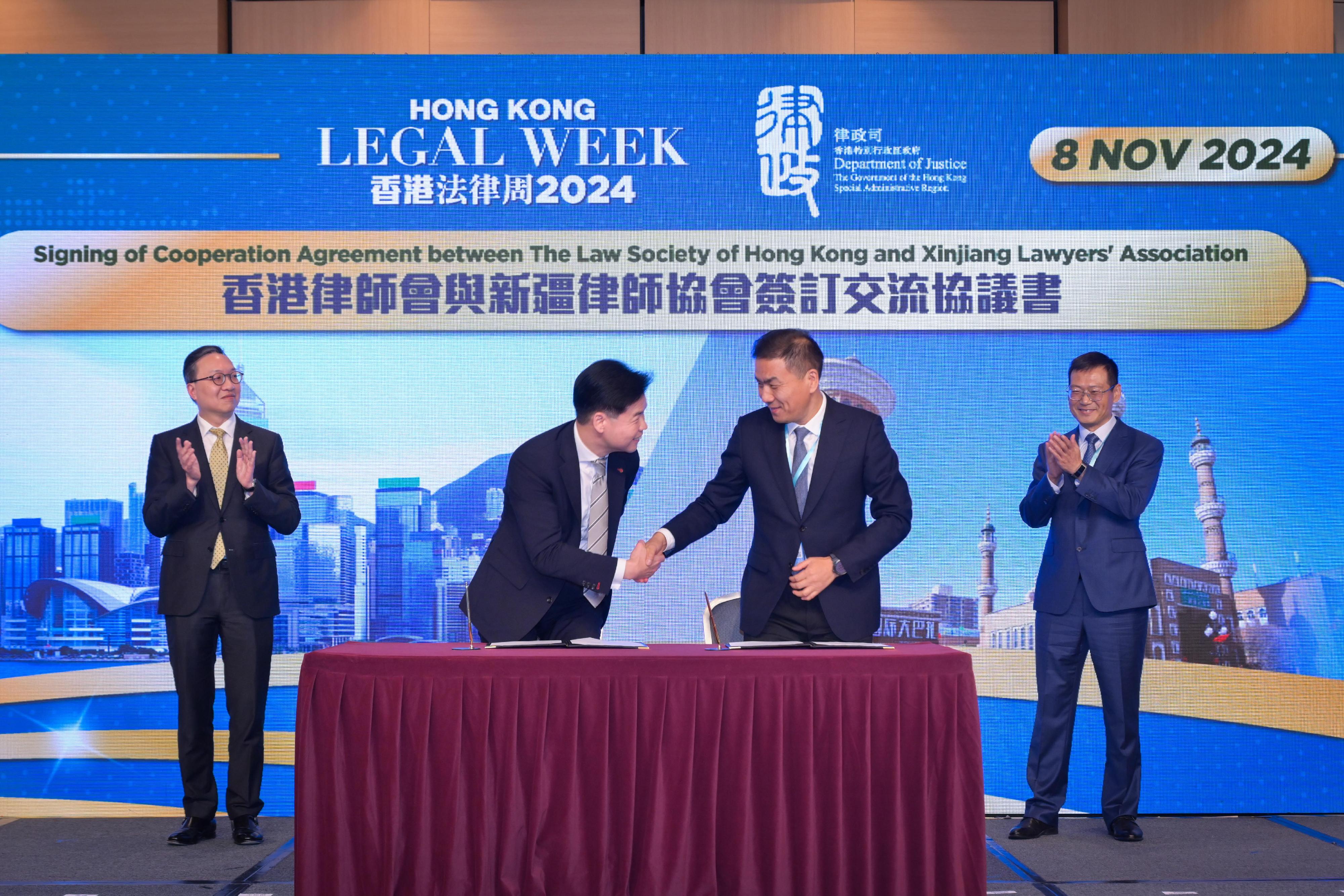 The Rule of Law: The Best Business Environment event was held today (November 8) as the finale of Hong Kong Legal Week 2024. Photo shows the Secretary for Justice, Mr Paul Lam, SC (first left), witnessing the signing of the co-operation agreement between the Law Society of Hong Kong and the Xinjiang Lawyers Association to facilitate regular exchanges and strengthen collaboration.

