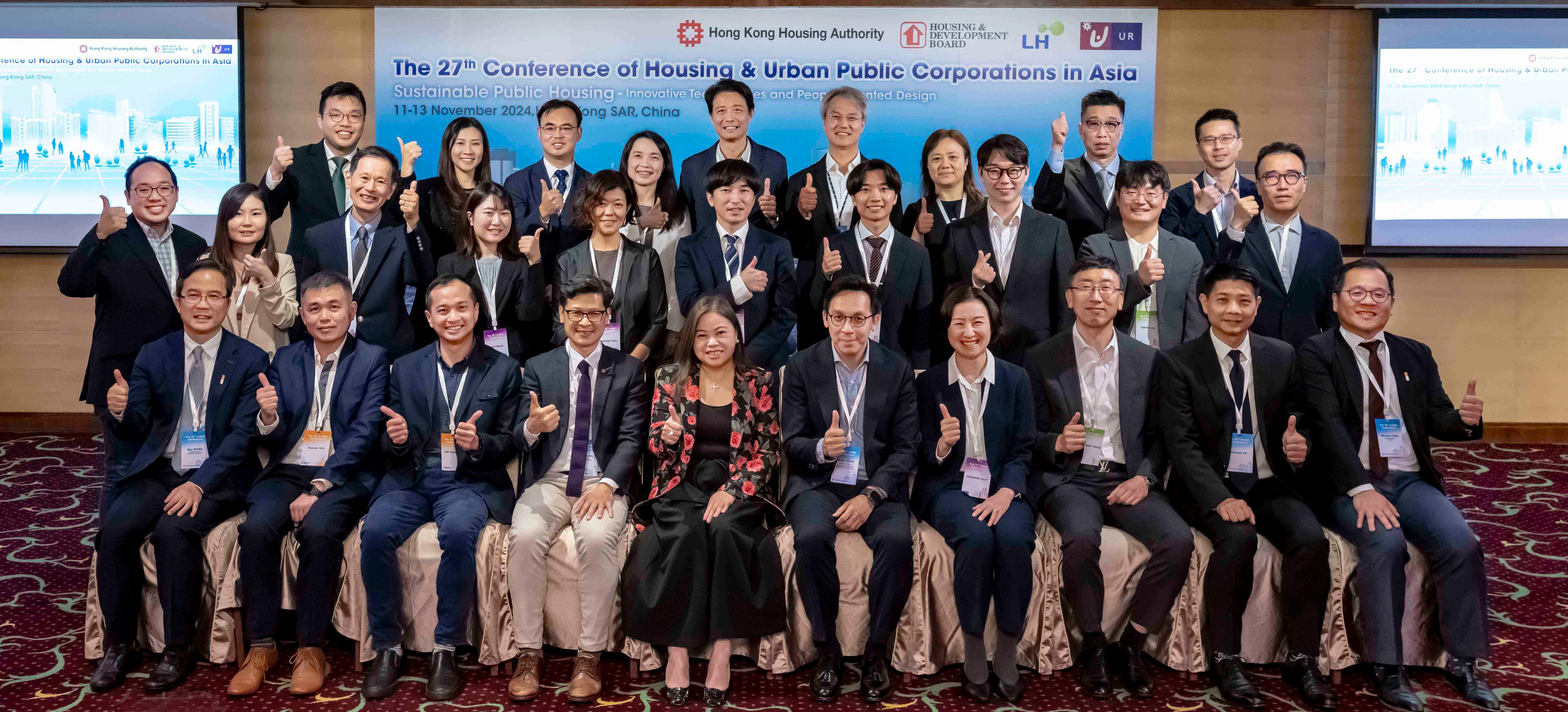 The 27th Conference of the Housing and Urban Public Corporations in Asia (A-HUC) hosted by the Hong Kong Housing Authority (HA), concluded today (November 13). Photo shows the Permanent Secretary for Housing and Director of Housing, Miss Rosanna Law (front row, sixth right), and representatives of the HA and A-HUC delegations from the housing authorities of Singapore, Korea and Japan on the first day of the A-HUC Conference on November 11.