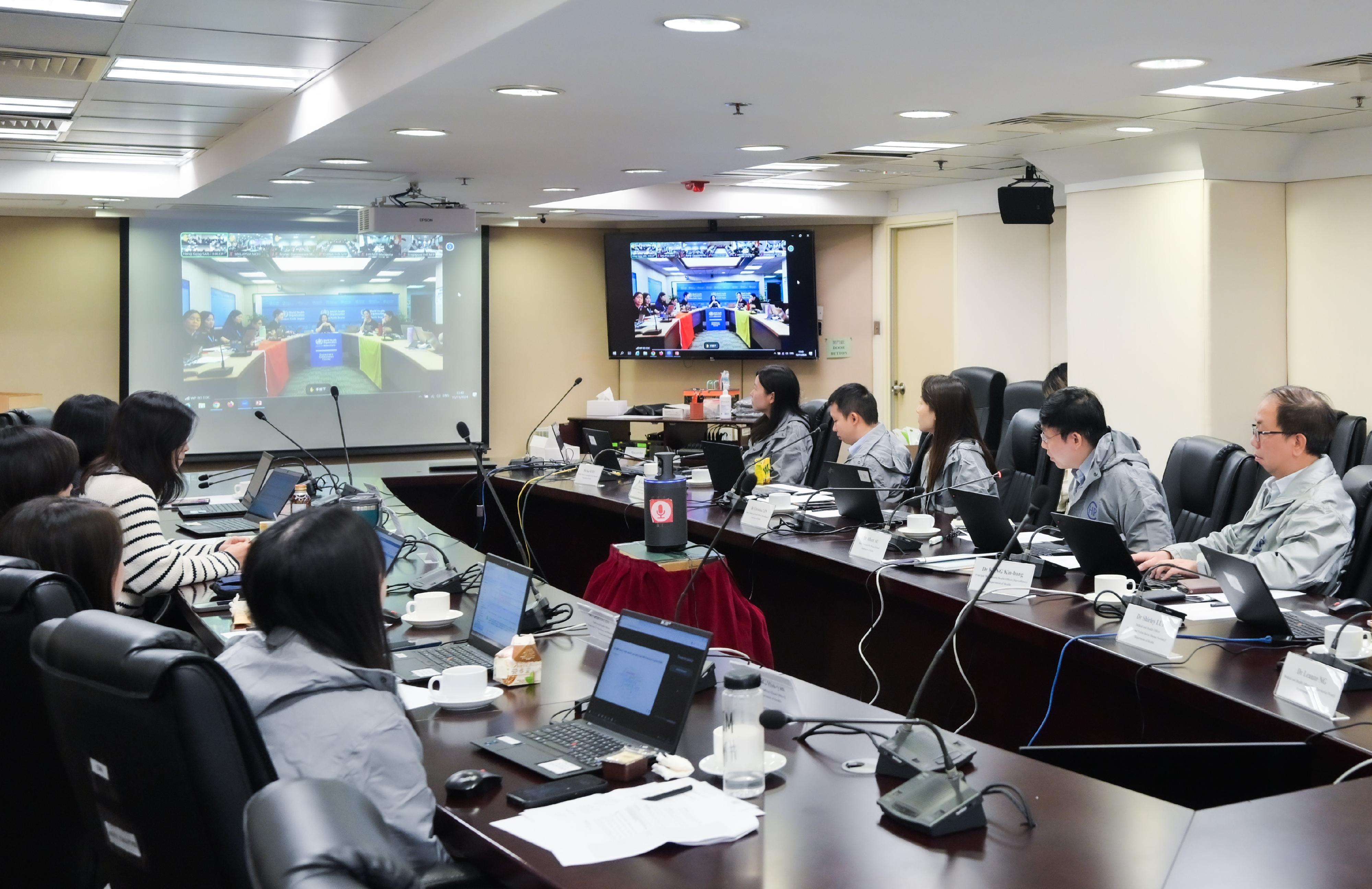 The Department of Health, yesterday (November 13), participated in the annual International Health Regulations Exercise Crystal organised by the World Health Organization's Regional Office for the Western Pacific (WPRO) to enhance public health emergency preparedness and response systems. Representatives of the Environment and Ecology Bureau and the Food and Environmental Hygiene Department also joined the exercise. Photo shows a debriefing and experience-sharing session by participants led by the WPRO.