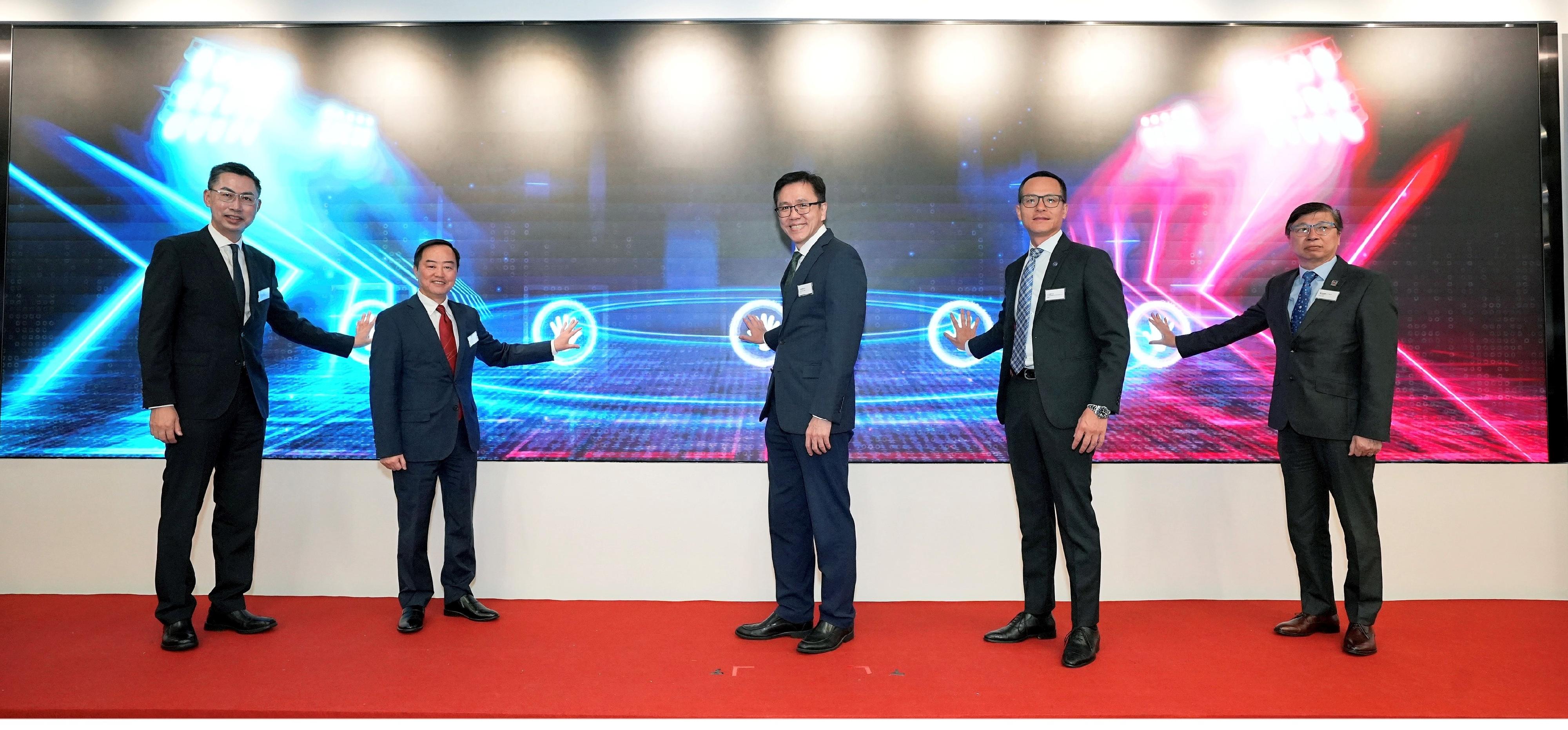 The Secretary for Innovation, Technology and Industry, Professor Sun Dong (centre), officiates at the opening ceremony of the Hong Kong Cybersecurity Attack and Defence Drill 2024 today (November 15) with the Commissioner for Digital Policy, Mr Tony Wong (second left); the Chief Superintendent of the Cyber Security and Technology Crime Bureau of the Hong Kong Police Force, Mr Raymond Lam (second right); the Chief Executive Officer of the Hong Kong Internet Registration Corporation Limited, Mr Wilson Wong (first left); and Deputy Executive Director of the Vocational Training Council Dr Eric Liu (first right).