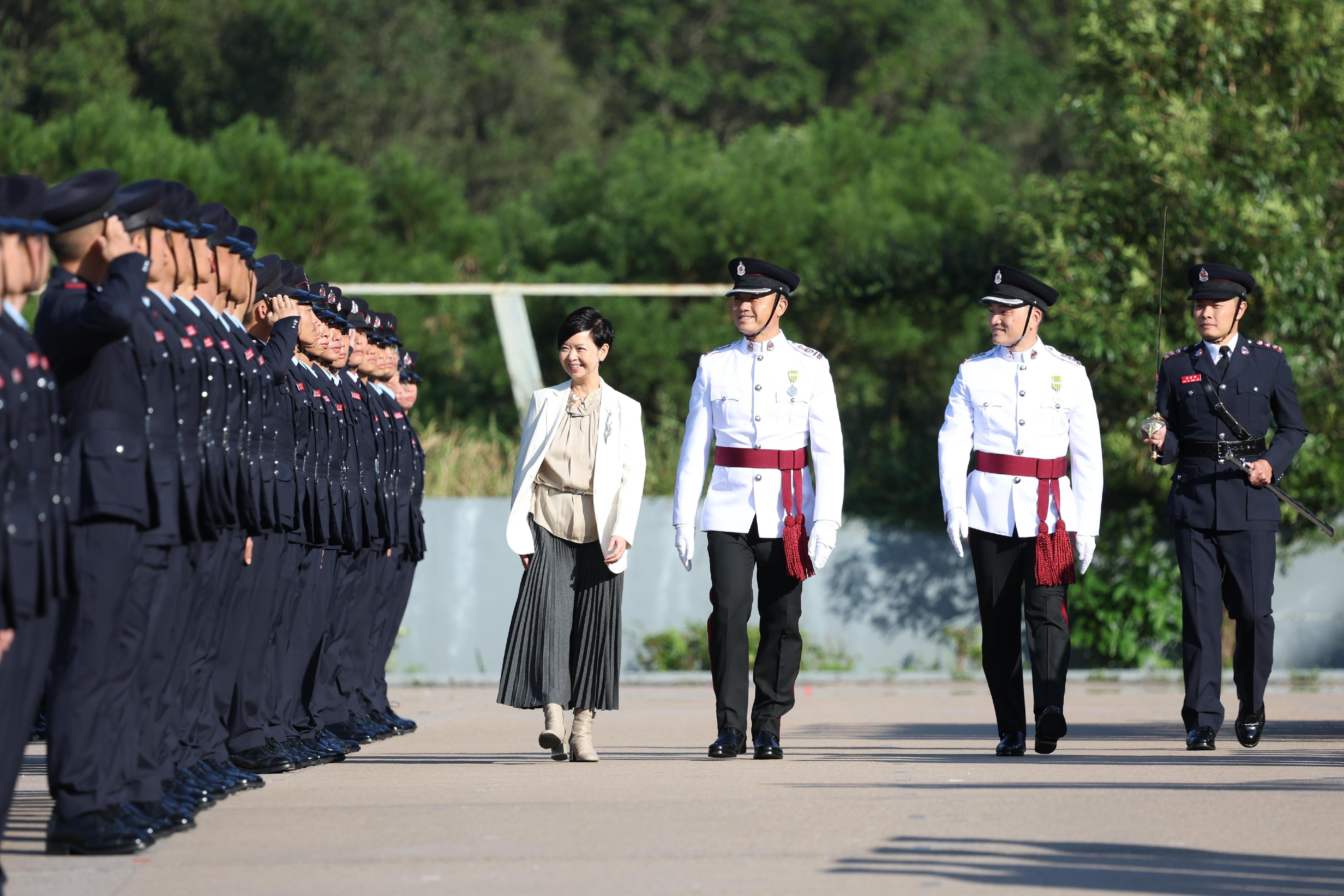 The Secretary for Housing, Ms Winnie Ho, reviews the Fire Services passing-out parade at the Fire and Ambulance Services Academy today (November 22).